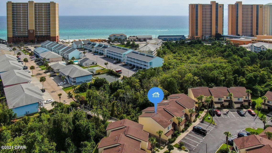 PRIVACY PRIVACY PRIVACY.... Closest home in the complex to the beach, end unit that backs up to your private green belt with no other unit behind you. The beach is just a short walk away.  It is located near Pier Park, Frank Brown Park, Aaron Bessant Park-restaurants, shopping, softball tournaments, concerts entertainment.  This little gem is tucked away in a uniquely quiet area.  Right by the boardwalk to the beach. The recessed back patio gives the feeling of peace and privacy. The master bedroom features a balcony overlooking the green space.  The upstairs bathroom can be accessed by the master bedroom or the hall.  A second bathroom is located on the first floor.  Home features ample storage closets on the back patio and on upstairs balcony. the master balcony upstairs. The complex also features an inground pool, tennis courts, and well kept grounds.