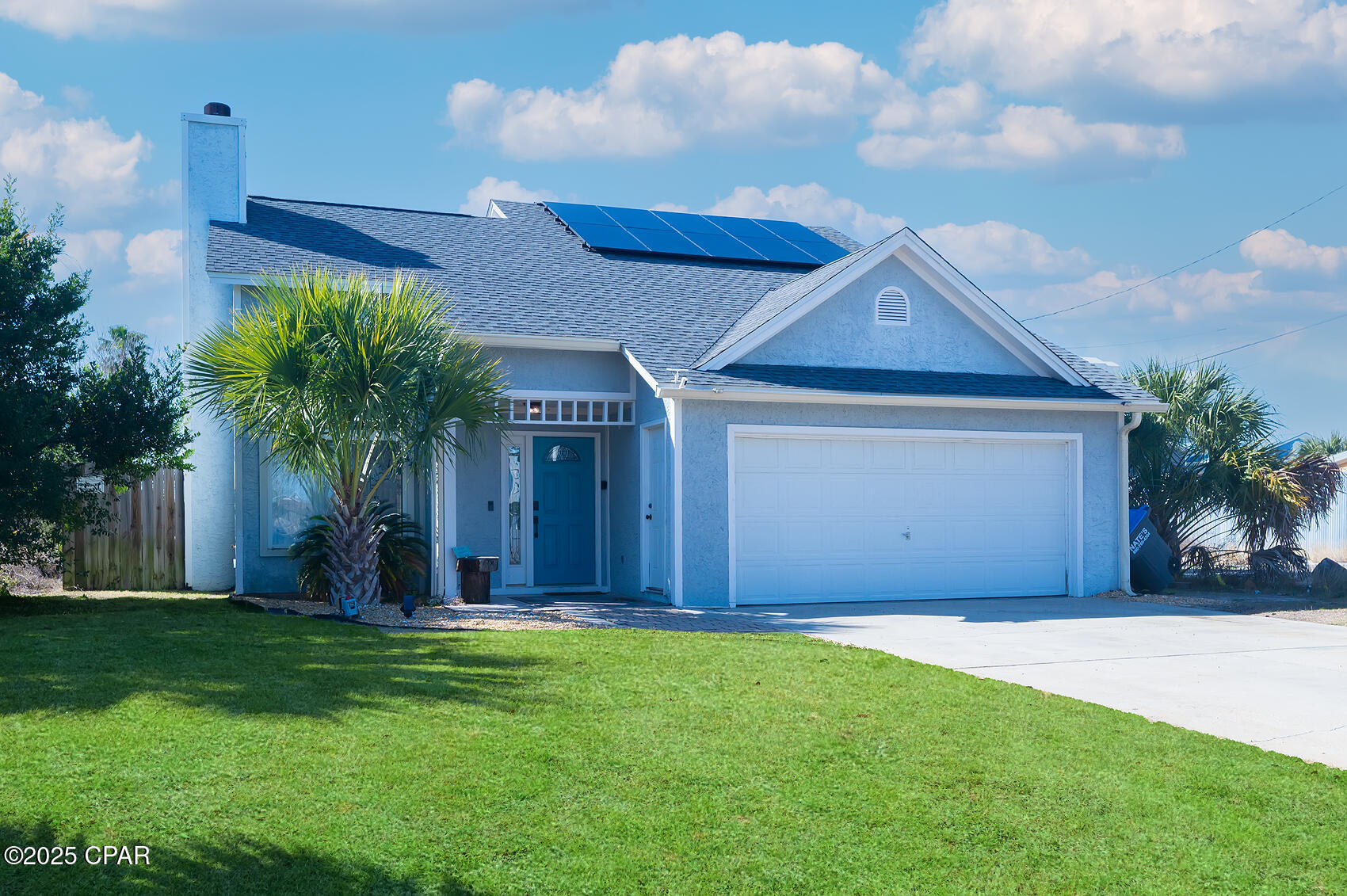 This beautifully updated beach home is the perfect getaway or investment property, located just a short distance from the sugar sand beaches, dining, and entertainment. Bright, open living room with soaring ceilings and a cozy fireplace. The recently remodeled kitchen features stainless steel appliances, butcher block, perfect for cooking and entertaining.

The main floor offers laminate flooring, a spacious master suite, and a second full bathroom. Upstairs you'll find durable vinyl plank flooring, a full-sized bedroom, and a versatile open loft - ideal as a home office, reading nook, or bunk space for extra guests.

Additional features include:

* 2-car garage with poly-treated flooring
* Large, level fenced backyard - perfect for kids, pets, and to add a pool
* Sprinkler system
* Fresh exterior paint (2021)
* Termite bond
* AC mini split
* Newer paid-off **solar panels** for low energy bills
* Just 3 blocks to the public boat launch on Dolphin Drive
* Easy golf cart ride to **Schooners** and **St. Andrews State Park**
Short term rental approved!
Everything you need for a relaxing beach lifestyle or a top-performing rental is right here!