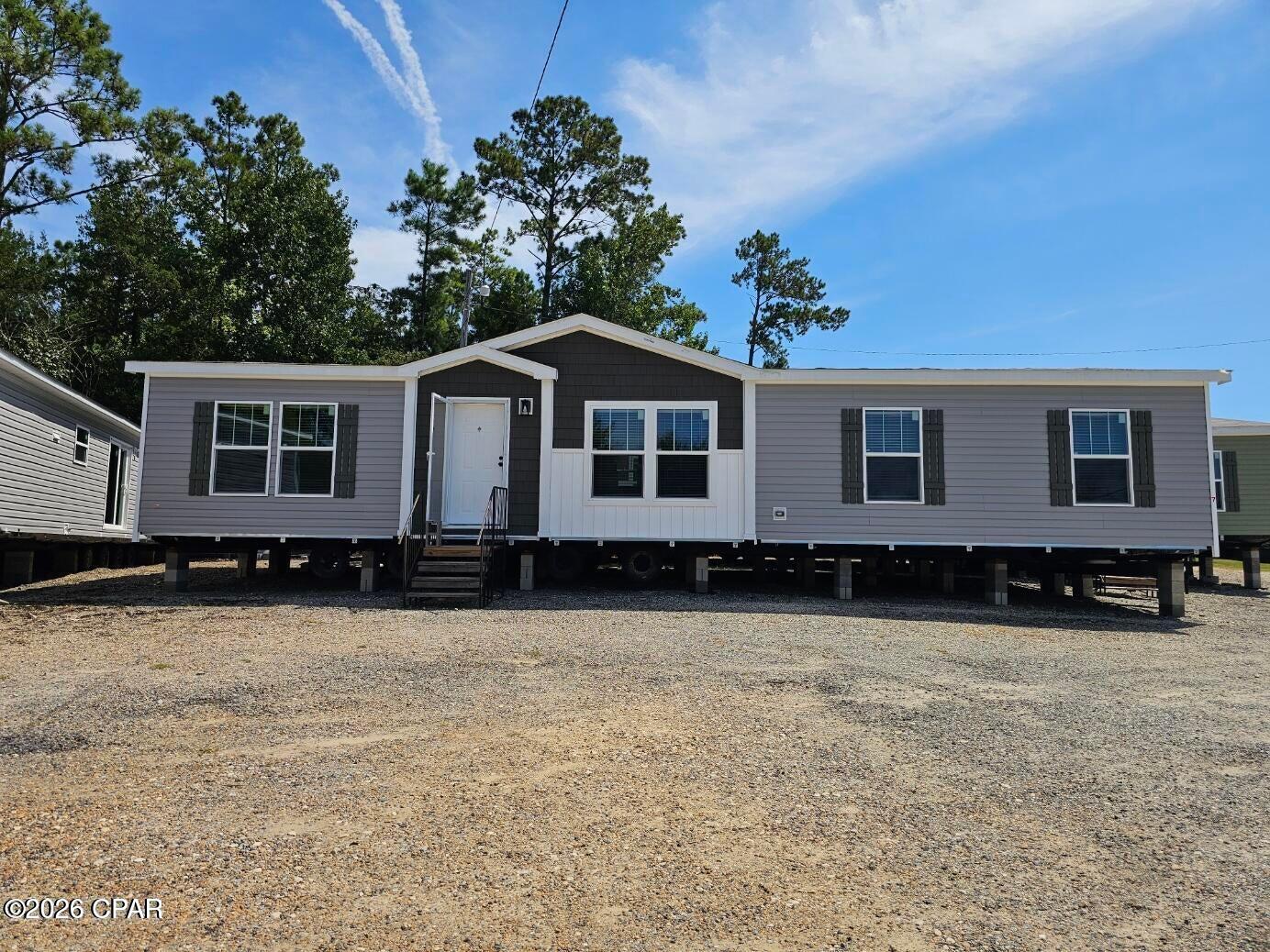 Brand new 2026 ''The Boujee 56'' this double-wide manufactured home offers a spacious 1531 square feet of living space designed for modern family living. With three bedrooms and two full baths, there's plenty of room for everyone to thrive. The home features durable 2x6 exterior wall construction for enhanced insulation and energy efficiency, plus finished sheetrock walls for a clean, contemporary look. A ceramic shower adds a touch of everyday luxury. Located in Compass Lake where residents enjoy a tranquil setting just 30 minutes from Panama City, providing a great balance of peaceful community living and easy access to city amenities. This property is ideal for families seeking a fresh, move-in-ready home in a welcoming neighborhood. All measurements to be verified by buyer