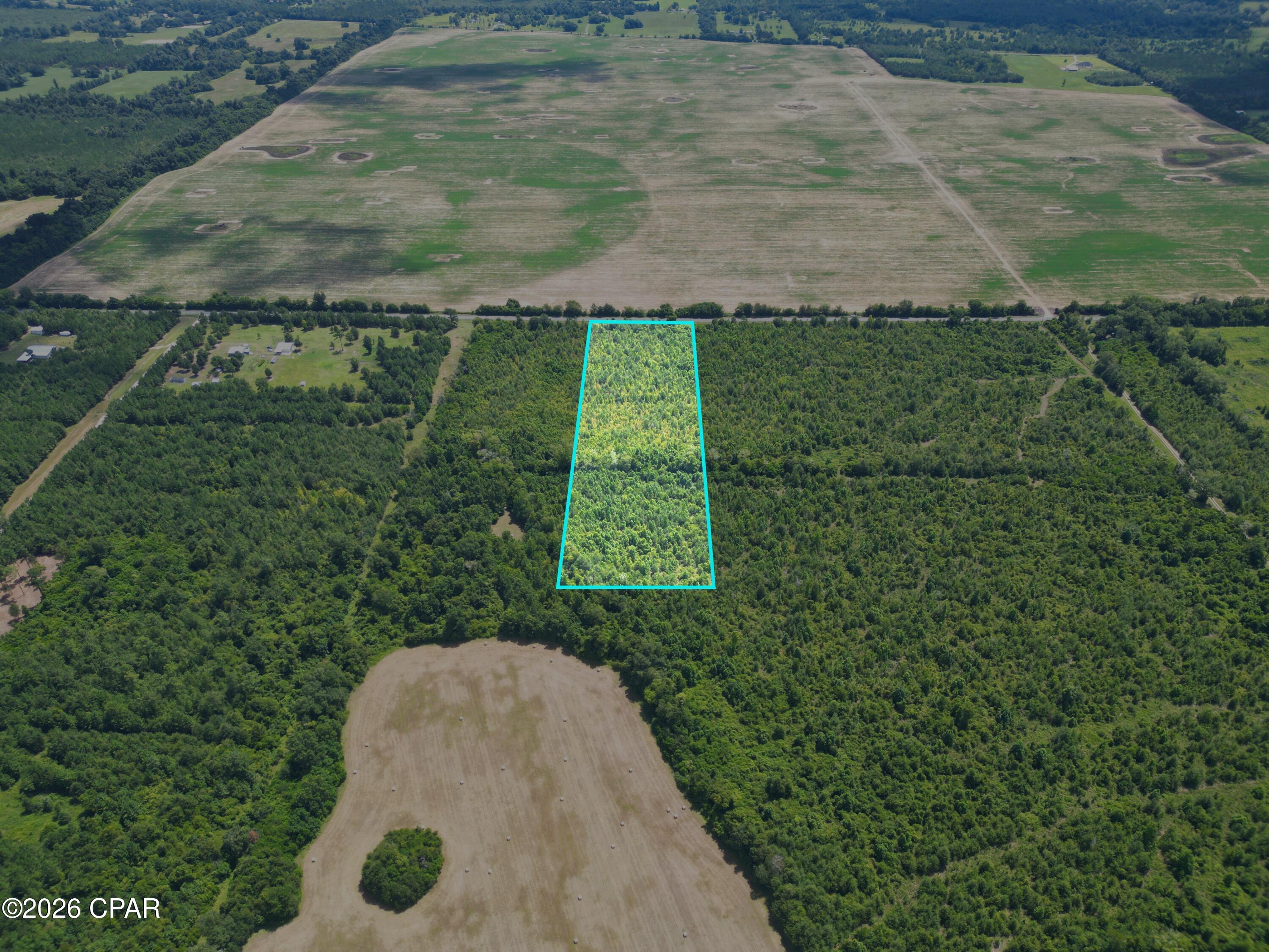 Great opportunity to own 10.07 acres in a convenient location! This flat, dry parcel offers paved highway frontage and plenty of space for a new homesite, recreational use, or hunting. Enjoy country living just 2 minutes from Blue Springs, approximately 7-8 minutes from downtown Marianna, and only 5-7 minutes from Marianna K-8 and Marianna High School. Don't miss the possibilities this beautiful property has to offer!