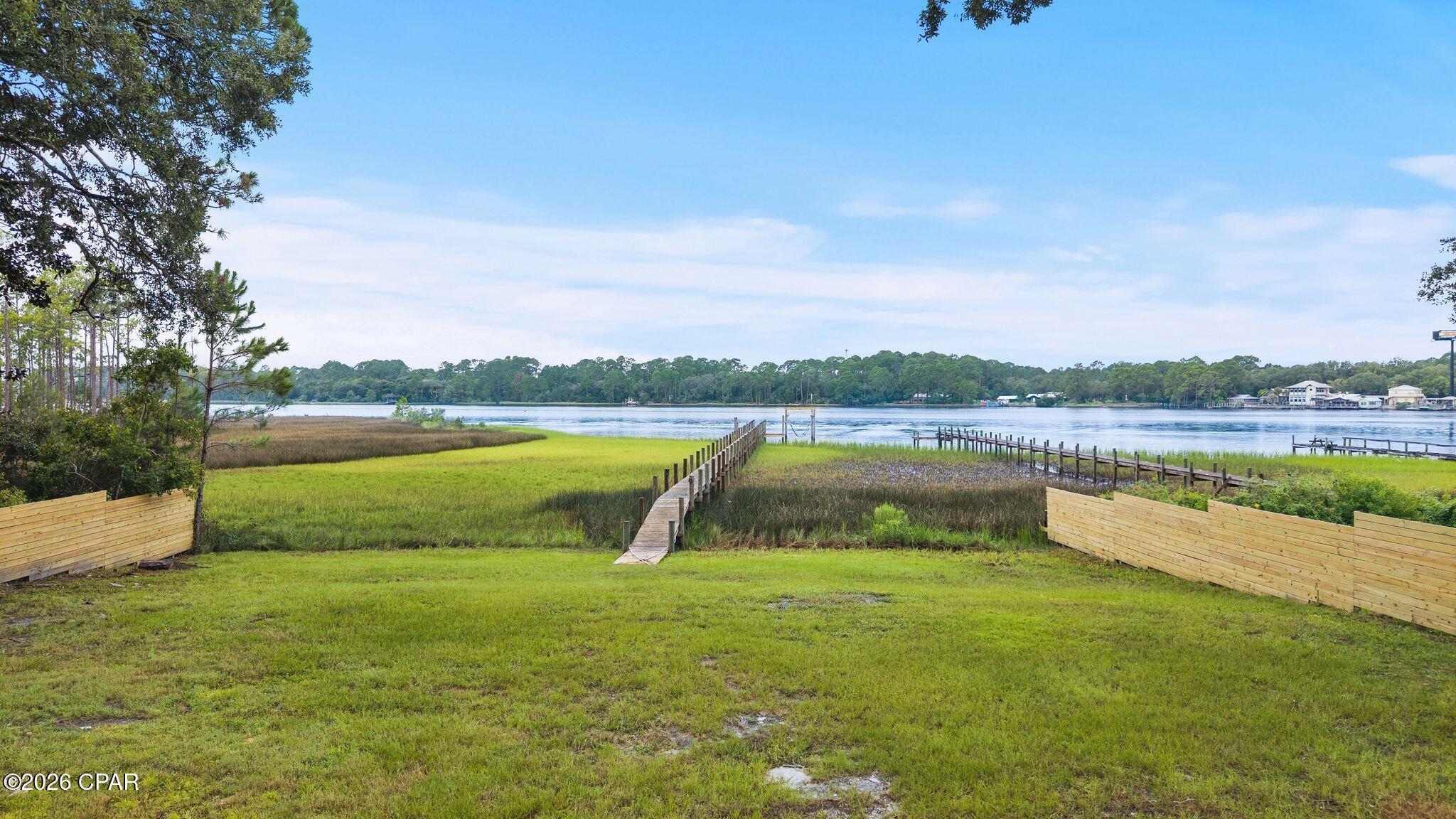 RARE WEST BAY WATERFRONT OPPORTUNITY! Discover the privacy, boating access and natural beauty of this approximately half-acre waterfront homesite tucked away on a quiet street with very few neighboring lots. Much of the groundwork has already been completed, including a new private dock, boat lift, well, and beautiful white pine privacy fencing accented by masonry columns.

Step from your future home onto your own dock and enjoy direct access to West Bay and the Intracoastal Waterway, with boating access to St. Andrews Bay and the Gulf of Mexico. Spend your days fishing, cruising the ICW, exploring Shell Island or heading offshore -- all from your own backyard.

The location becomes even more compelling as the West Bay/Highway 79 corridor continues to grow. Point South Marina West Bay is currently under development nearby, bringing additional boating infrastructure and amenities to this rapidly developing area.

What truly separates this property is its privacy and scarcity. With very few lots along this secluded street, opportunities to own a waterfront homesite with this combination of space, improvements and boating access are extremely limited.

Build your dream waterfront home and enjoy the best of both worlds: a peaceful, private setting surrounded by the natural beauty of West Bay while remaining convenient to Panama City Beach and the continued growth of the West Bay area.

Bring your boat and your plans -- the waterfront lifestyle starts here.