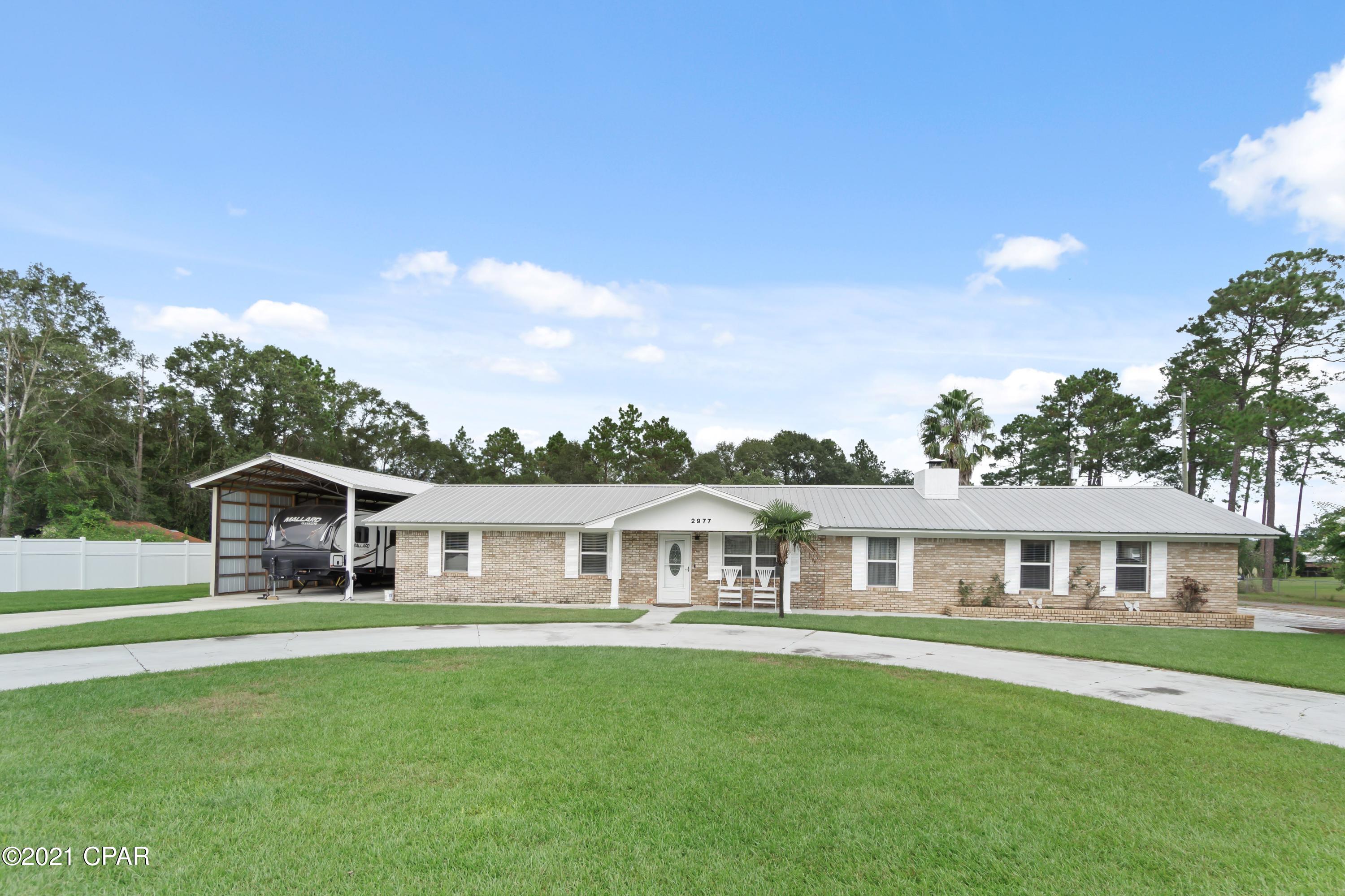 This 4 Bedroom, 2.5 baths in the edge of Bonifay has all you could want!!! Spacious open floor plan with plenty of room for entertaining.   Warm up in front of the large fireplace in the living room!  Kitchen (just off the breakfast area) features a ''smart'' refrigerator, custom cabinets, & tiled backsplash. The Owners Suite is on the opposite end of the home from the other three bedrooms & the bathrooms have custom tilework.  Outside you will find beautifully landscaped grounds with a large in-ground salt water pool & a gazebo to house your ''kitchen'' to cook & relax in the shade.  There is a large RV Shelter at the west end of the home, & a large enclosed workshop & boat/rv garage with access from Barefield Lane. Don't forget the large concrete area for basketball or any activity.