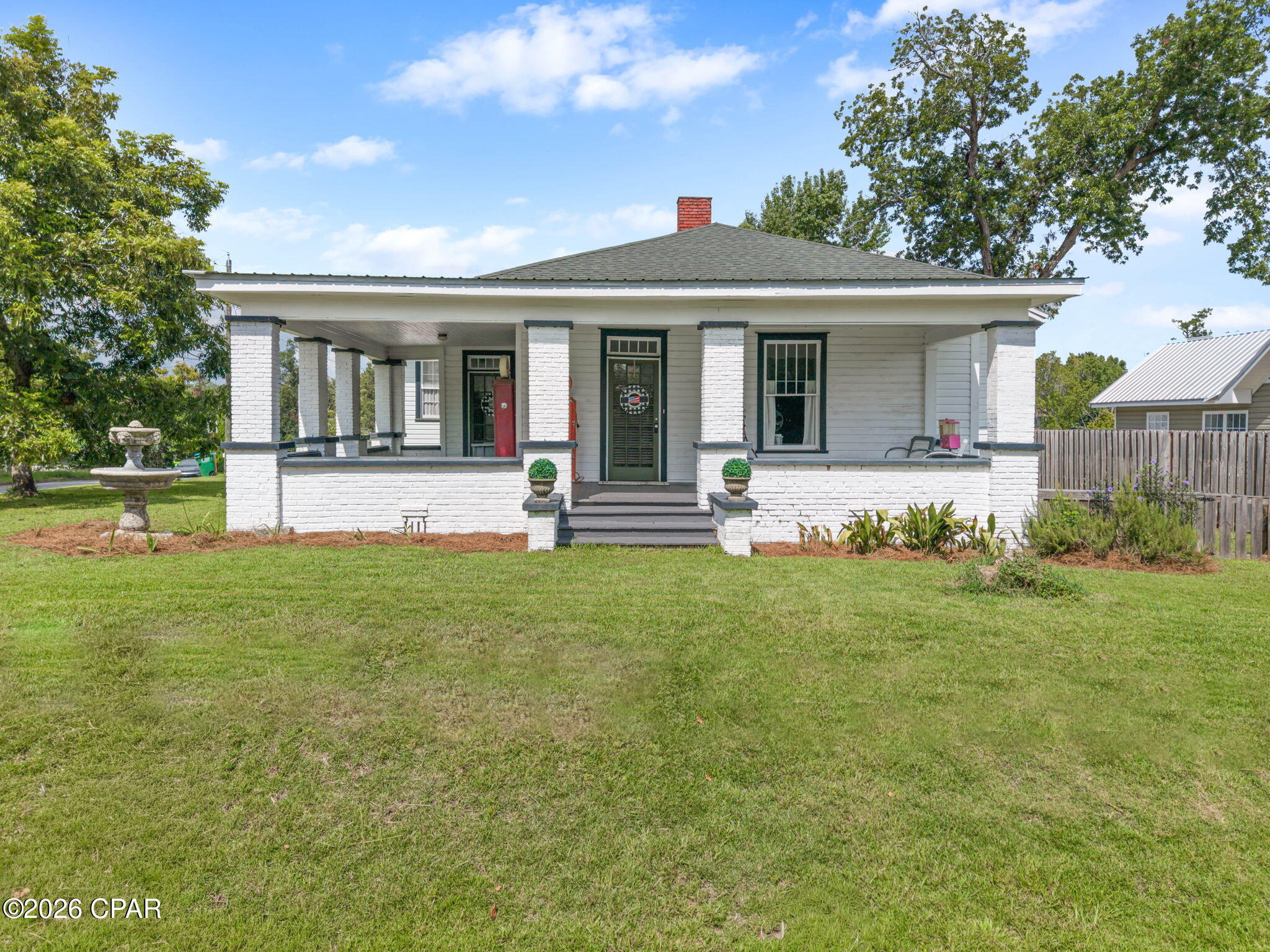 Beautifully renovated 3-bedroom, 2-bath home filled with character and charm that you simply don't find in newer construction! Step inside and you'll immediately notice the tall windows, beautiful wood ceilings, detailed trim and millwork, built-ins, and decorative fireplaces that preserve the home's timeless appeal. Thoughtful updates throughout provide modern comfort while allowing the original character to remain front and center. Improvements include updated flooring, fresh exterior paint, a new HVAC system, hot water heater, along with a refreshed kitchen that offers plenty of room to cook and gather. The spacious kitchen features updated appliances, butcher block countertops, painted cabinetry, a beautiful farmhouse sink, and an abundance of workspace and storage while still complementing the character of the home. The home offers a welcoming living room, separate dining area, three bedrooms, and two full bathrooms, including a bedroom with its own en suite bath. Just off the living room, the gorgeous green room may quickly become a favorite spot in the home, with its rich woodwork, beautiful windows, and built-in window seat, it would make the perfect library, reading room, or cozy sitting area. The laundry room is surrounded by windows, bringing in plenty of natural light while providing additional space for everyday use. Outside, the home sits on a corner lot with plenty of room to enjoy the outdoors. The covered front porch adds to its classic Southern charm and offers the perfect spot for rocking chairs and relaxing, while the covered parking area provides convenient space for vehicles and additional outdoor use. Located in the heart of Marianna, you'll also enjoy being close to downtown, shopping, dining, parks, and everyday conveniences. Beautifully updated without taking away the details that make it special, this home offers a wonderful blend of historic character, modern conveniences, and one-of-a-kind spaces throughout. If you're looking for a home that feels anything but cookie-cutter, this one deserves a closer look!