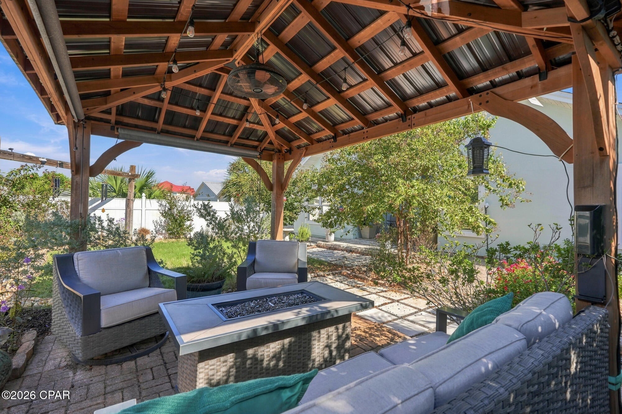 Just 0.7 miles from Public Beach Access 13, this beautifully maintained 3-bedroom, 2-bath home offers the space, privacy, and outdoor living that make Panama City Beach living so appealing--with no HOA. From the inviting tropical landscaping to the soaring ceilings and light-filled interior, the home makes a strong impression from the moment you arrive.
Inside, the open layout features impressive ceiling heights, oversized windows, and new luxury vinyl plank flooring throughout the main living areas. The kitchen is both functional and inviting, with abundant cabinetry, stainless steel appliances, quartz countertops, a large island with a deep single-basin sink, and a glass-and-stone mosaic backsplash. The adjoining dining area overlooks the backyard and flows naturally into the spacious living room.
The primary suite offers a tray ceiling, walk-in closet, and private bath with a soaking tub, separate shower, dual vanity, and quartz countertop. The guest bath has also been updated with a quartz vanity and contemporary finishes.
The backyard is where this home truly stands out. Fully fenced and surrounded by mature landscaping, it features multiple paver areas, a covered patio, and a substantial pergola with a metal roof, ceiling fan, lighting, and fire table--an ideal setting for morning coffee, outdoor dining, or evenings with friends. There is also a separate patio area for additional outdoor seating and entertaining.
Fresh exterior paint, a refreshed white-rock yard and driveway, and a 2-car garage complete the property. The generous driveway provides ample parking, with potential boat parking, subject to applicable regulations.
The roof was replaced in May 2026.
Enjoy the convenience of being close to the Gulf, dining, shopping, boating, and entertainment while coming home to a quiet residential setting. With no HOA, a new roof, exceptional outdoor living, and the beach just minutes away, this is a property that offers both lifestyle and flexibility.