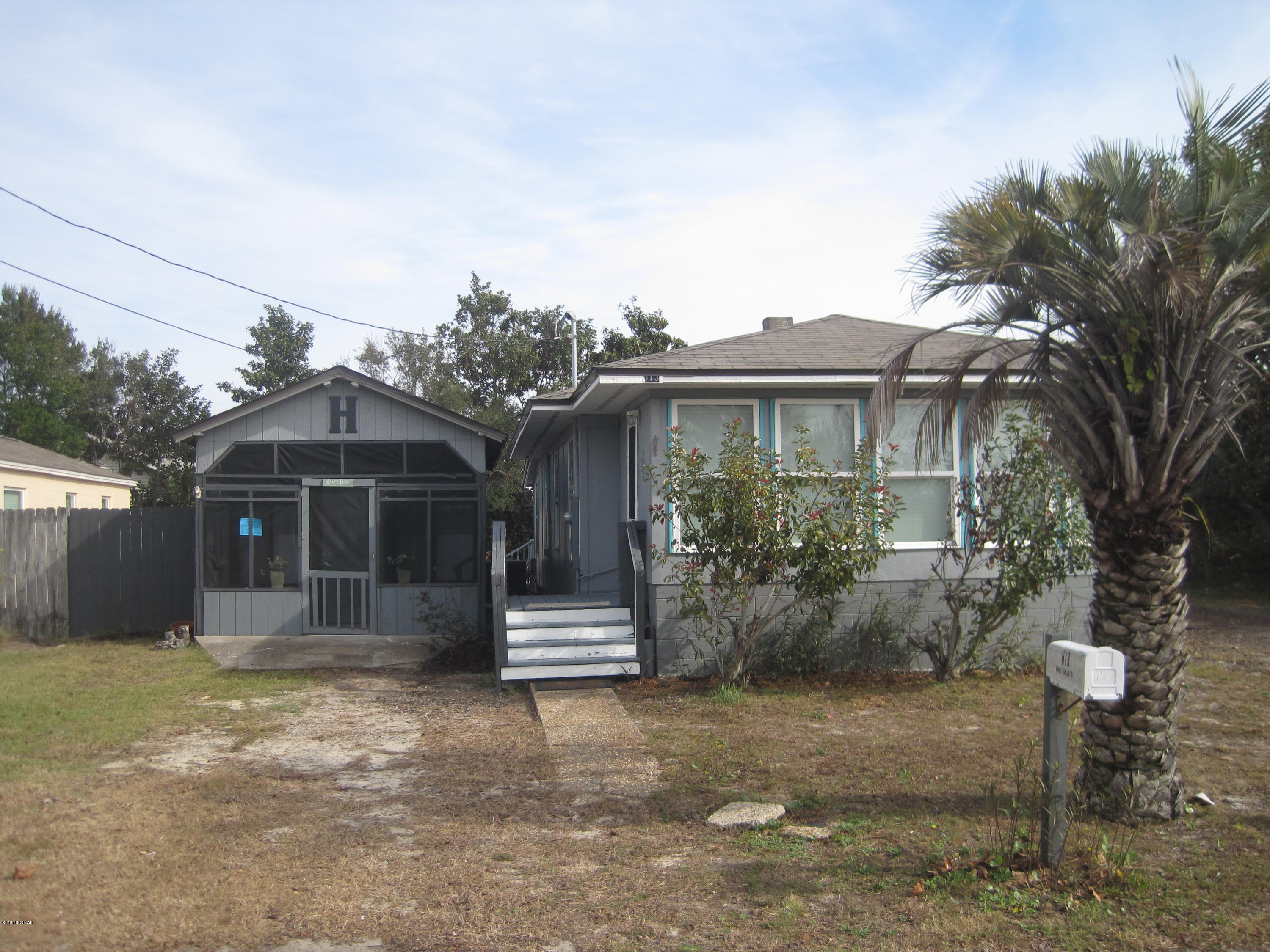 Week old roof and newer AC unit.  All new insulated windows. This one of a kind cozy cabin style home has a lot to offer. Florida room in the front and open air deck in the back. Hardwood floors throughout. 2 bedroom with 1 full bath and a 3/4 bath. Walk-in closet in master. Large living room has an electric fireplace.  In the back of the converted garage has a studio apt. In the front it has a she shed / man cave. In between those two is a large utility / storage room. This property is only 975 feet from the beautiful white sandy beaches. This house is in a prime location, close to a lot that the beach has to offer.  RV parking with water, power and  waist hook-up. NO HOA FEES. Great investment opportunity.