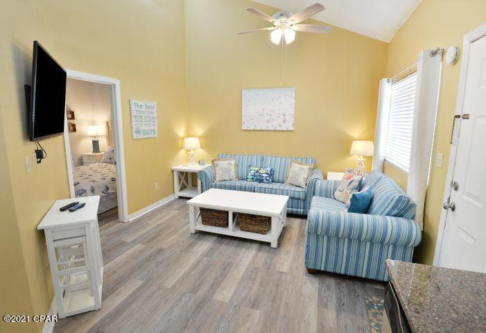 Quiet west end unit just steps from the the beautiful Panama City Beach. This condo has had a complete kitchen update with new granite countertops, new cabinets, stainless appliances, new flooring installed in 2018. Great rental potential, this top floor unit has sky windows, gulf view, and escalating ceilings making it very roomy and light. Complex pool and outdoor grills. Beach access is directly across street. New water heater installed in September 2015. All info and measurements are approximate, buyer to verify if important.