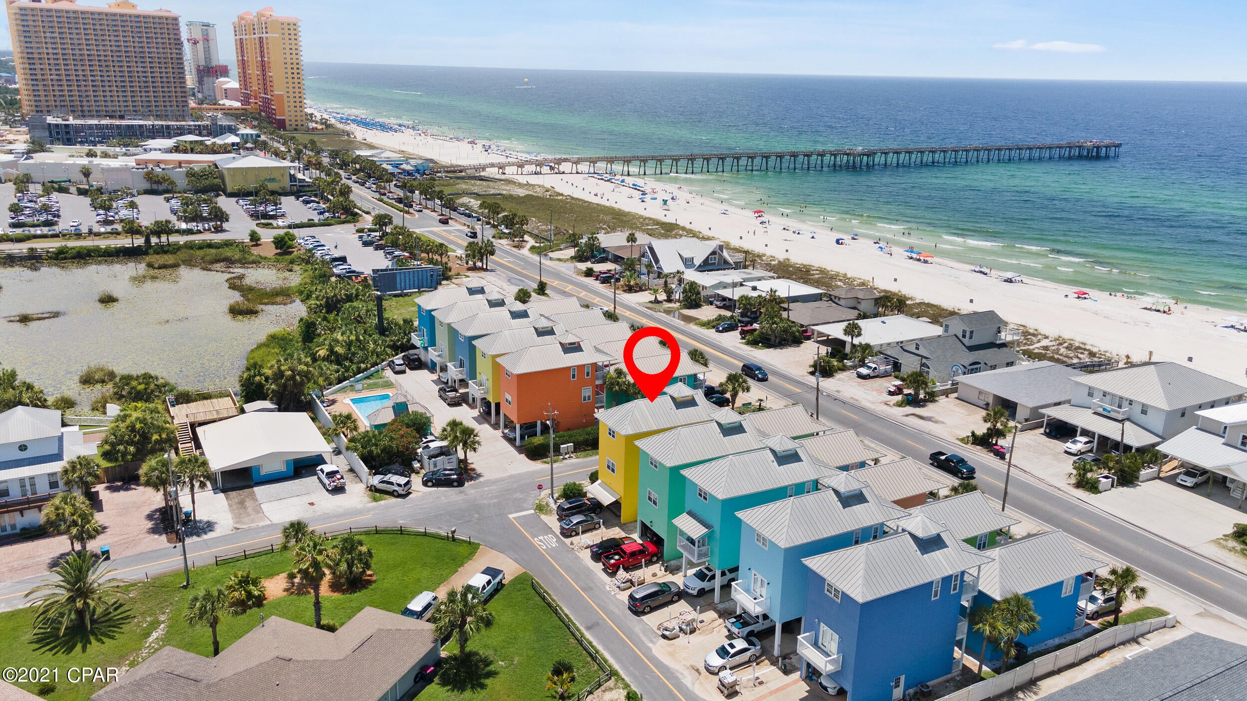 BEAUTIFULLY MAINTAINED and  FULLY FURNISHED townhome steps away from Pier Park and the dog beach!!!  Incredible rental income potential and STR allowed. Vaulted ceiling, wood and tile flooring throughout, freshly updated with a modern color palate, thoughtful furnishings.  All of this and a spectacular VIEW!!! Many upgrades and unique features you simply MUST see!  This will NOT last long!  Professional photos will be added soon. BUYER TO VERIFY ALL INFORMATION DEEMED IMPORTANT. House #10 was the only house originally constructed with a garage, and has a side door entry for easy access to the outdoor shower after those beach trips. There is large overhead storage space in the garage. There are two additional windows on the 3rd floor - in the kitchen by the fridge, and the double windows behind the sofa.  All full bathrooms have windows.  All bathrooms have newer chair height water saving toilets.  A reconfigured master bathroom added space and it has a jacuzzi tub.  A walk-in master closet that is a sitting area in other 3 story homes.  Newer oak hardwood floors and original 17 inch diamond laid tile.  Coffee bar with microwave.  Hands free kitchen faucet.  Electric awning over the driveway
Perforated Hardi-board soffit for the cupola is sturdier than vinyl soffit.  50 inch TV in the garage.  Large capacity commercial 'fridge in the garage.  GE Platinum side-by-side 'fridge in the garage with a high capacity ice maker (2 days to fill the large ice bucket).  New exterior Amana AC unit.  Dimmer switches for all 3rd floor lighting (kitchen, dining and living room).  800 watt stereo/DVD player with 3D capabilities, and a 3D capable Visio TV.  A new smart TV's in each bedroom.  All interior furniture/accessories and deck furniture are included .  High end bedding and linens are included
Fire monitoring system has been installed, and is required for 3 story homes that rent. It was inspected and repaired by Hiller Fire Company in June. For renters they must add the required radio for about $200 from Hiller..  The house has had a termite inspection/bond for 17 years, and now there is a brand new Sentricon termite system that was installed in May 2021.