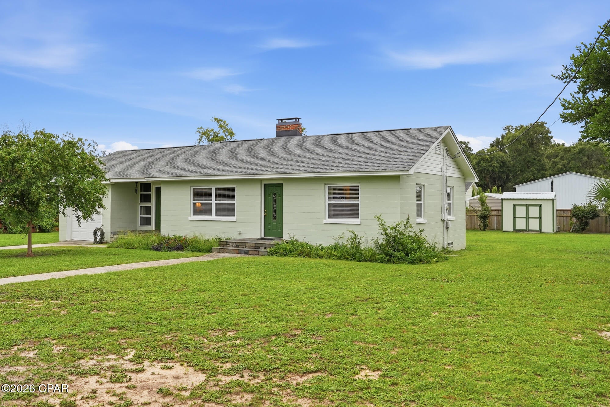 This updated Florida cottage offers comfortable coastal living in the heart of Beach Drive/Lake Caroline area. Located a short walk or golf cart ride from Beach Drive beaches and local St Andrew's shopping and dining, the property combines a classic look with extensive modern updates. The home sits on a rare, large lot of nearly half an acre, providing plenty of space for future additions, a pool, or new construction.The interior has been fully updated for turn-key convenience. Features include refinished original hardwood floors with a durable polyurethane finish, brand-new ceilings in all rooms, and custom built-in bookshelves next to the fireplace. The kitchen includes new custom wood cabinets, and the master suite features a cedar-lined closet. Additional living spaces include a sunlit Florida room and a utility room, both upgraded with new tile flooring.Every major home system and structural component has been replaced or updated for peace of mind. The exterior features a brand-new roof with all underlying wood replaced, 30-year warranty shingles, new windows, and new doors. Inside the walls, the home has been fully re-wired and completely re-piped with flexible water lines. Comfort and utility are handled by a new high-efficiency A/C unit with a heat pump installed in January 2026, a recently replaced water heater, a new storage shed, and a full irrigation system powered by a brand-new 2026 well pump. This property offers a rare combination of a prime St. Andrews location and completely updated, low-maintenance systems.