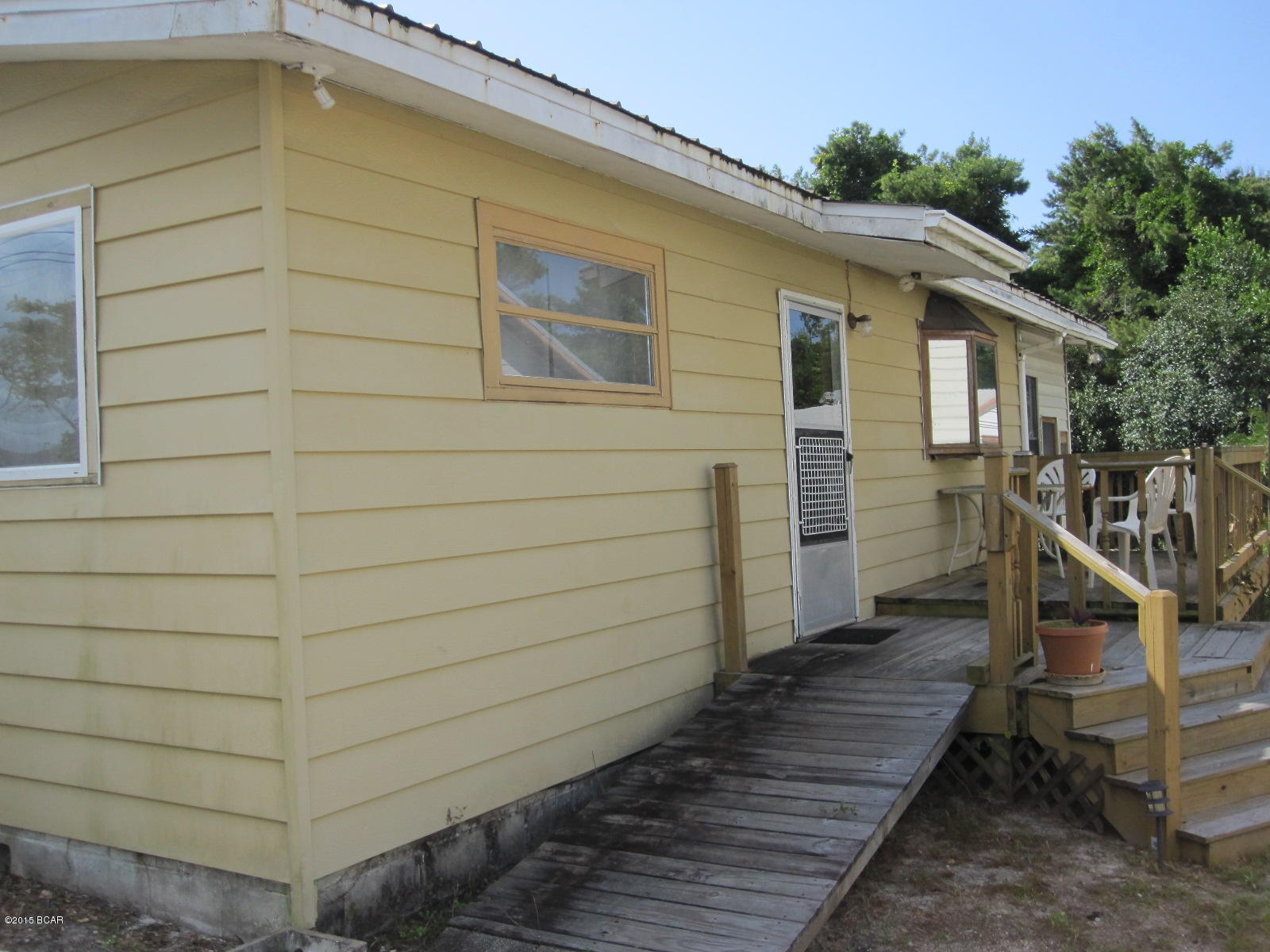 Florida style beach cottage on West end of Panama City Beach. This little jewel needs some work but would make a great weekend retreat to come enjoy the beach. Several New Construction homes in the neighborhood will only help to increase your equity. The original hardwood floors need refinishing but will look great when done. Two bedrooms 1 bath. The bath has been upgraded. The previous owner states the metal roof is about 8 years old and central AC was replaced approx 2 years ago. Florida room off the back of the home. Big storage yard building in back. Your weekend getaway awaits!