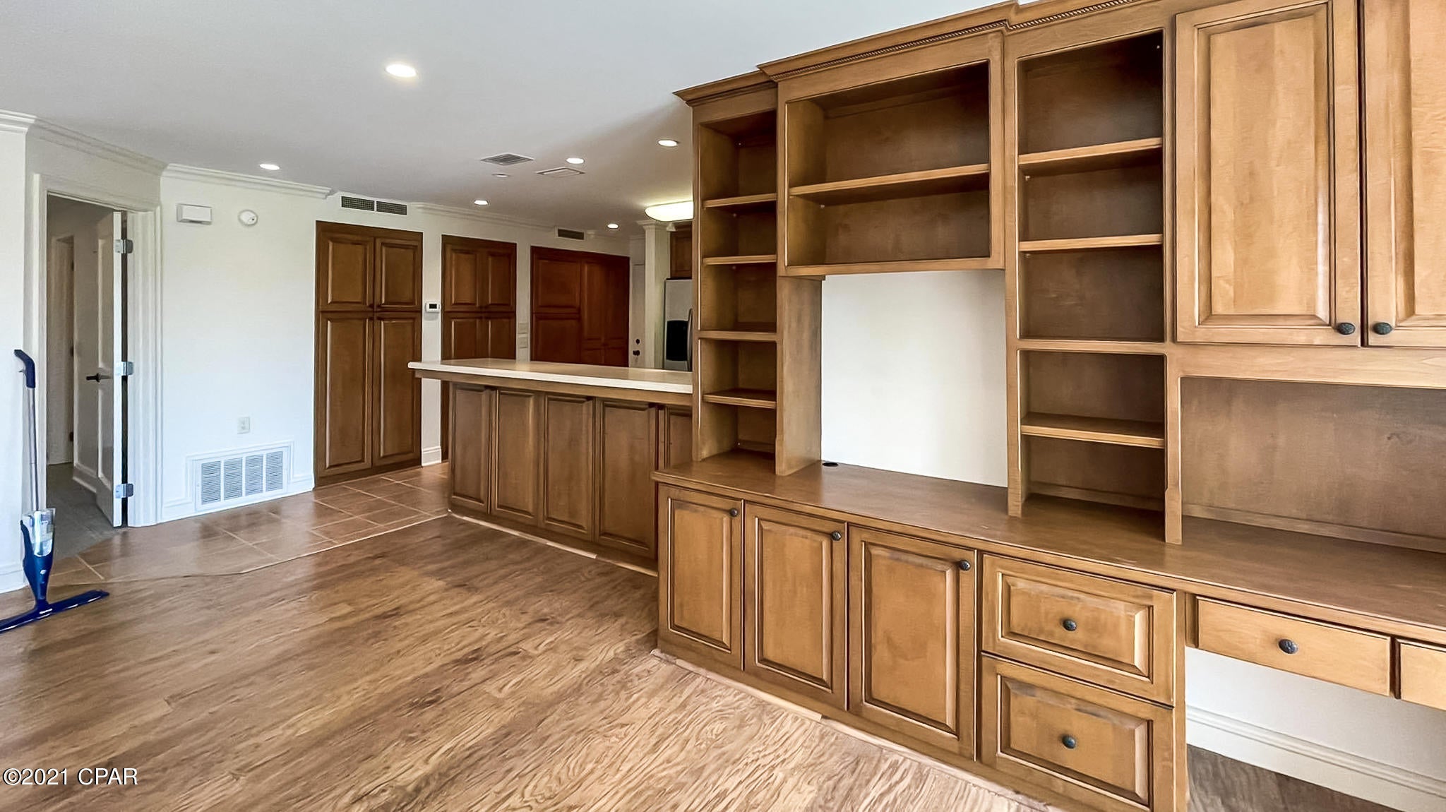 This is a custom designed and remodeled ground floorplan. This was built with permanent living in mind.  There is an enormous amount of custom cabinets in  great room and kitchen area.  The bath has a large tiled shower, and his and her closets. Crown molding and other upgrades are seen in this condominium. Easy to show.