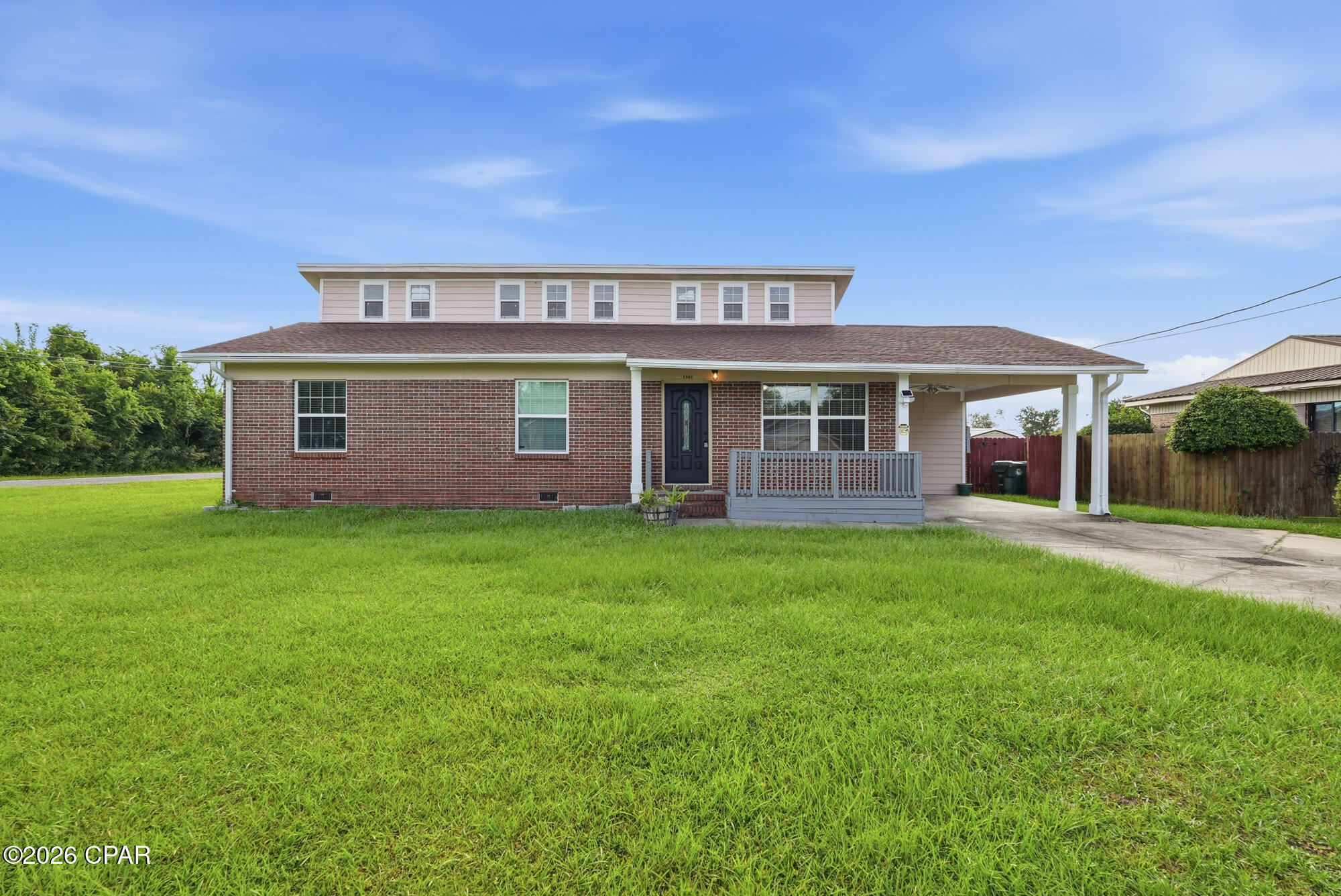 Welcome to 1501 Alabama Ave, a distinctive 3-bedroom, 2-bath home offering approximately 1,600 square feet of interior living space on a spacious 0.285-acre corner lot in the heart of Lynn Haven.

Although originally built in 1972, the home benefited from substantial improvements during approximately 2020-2021, including a 2020 roof, a 2020 HVAC system, and major additions to the property's outdoor-living environment. These improvements give buyers the character and space of an established home together with several important, more recent upgrades.

Inside, the main living area features dramatic approximately 18-foot ceilings that create an open, spacious atmosphere rarely found in homes of this size. The kitchen and dining area connect naturally to the exterior living spaces, making the home especially well suited for everyday living, entertaining, and indoor-outdoor enjoyment.

One of the property's most significant features is its expansive connected outdoor environment. The large cedar deck, patio, pergola, porch, walkways, privacy fencing, mature treeline, and open yard provide multiple areas for dining, entertaining, relaxing, gardening, pets, recreation, and future personalization.

The corner-lot configuration, long approach, spacious front and rear yards, and privacy features create a sense of openness and separation that can be difficult to find in more tightly developed neighborhoods.

Additional features include covered one-car carport parking and a raised approximately 96-square-foot storage shed with a high ceiling and built-in shelving. The shed is not currently powered.

The property is centrally located near parks, restaurants, shopping, schools, Highway 77, and Highway 390, providing convenient access throughout Lynn Haven, Panama City, North Bay, Tyndall Air Force Base, Naval Support Activity Panama City, Northwest Florida Beaches International Airport, and the beaches of the Emerald Coast.

1501 Alabama Ave offers more than its bedroom count and interior square footage suggest. It combines dramatic interior volume, substantial outdoor utility, privacy, recent improvements, storage, and a flexible corner-lot setting designed for buyers who value space, character, and indoor-outdoor living.

Seller-provided dates, dimensions, and property information should be independently verified by buyers and their chosen professionals.


Just to put everything in perspective:

1,600 SQ FT INSIDE. 1,207 SQ FT OF DECK, PORCH & PATIO OUTSIDE.

THE LOT
A rare 0.285-acre corner lot in the heart of Lynn Haven -- fully privacy-fenced, mature treeline, spacious front and rear yards, with a long approach and flexible layout most in-town lots this size don't offer. Northern border is a green tree line, more privacy! 

THE INSIDE
Approximately 1,600 sq ft with dramatic approximately 18-ft ceilings in the main living area -- an open, airy volume rarely found in a home this size. Kitchen and dining flow straight out to the deck system.

THE OUTSIDE
Approximately 1,207 sq ft of connected outdoor living: an approximately 805 sq ft deck, covered porch, pergola, and patio. Vaulted porch ceiling with fan and lighting, covered and open-air gathering spaces, direct yard access. A true second living space, not just a backyard.

MOVE-IN READY
NEW ROOF (2020). NEW HVAC (2020). Full deck and outdoor-living rebuild. Updated porch. New side-by-side refrigerator with ice and water (July 2026). The big-ticket items are already done.

ALSO INCLUDED
Raised approximately 96 sq ft storage shed with built-in shelving. Covered one-car carport. Privacy fencing throughout.

LOCATION
Minutes to Tyndall Air Force Base, Naval Support Activity Panama City, Northwest Florida Beaches International Airport, downtown Panama City, and the Emerald Coast beaches. Quick access to Highway 77 and Highway 390. Close to parks, restaurants, shopping, and schools.

See the space in person -- request a showing today.