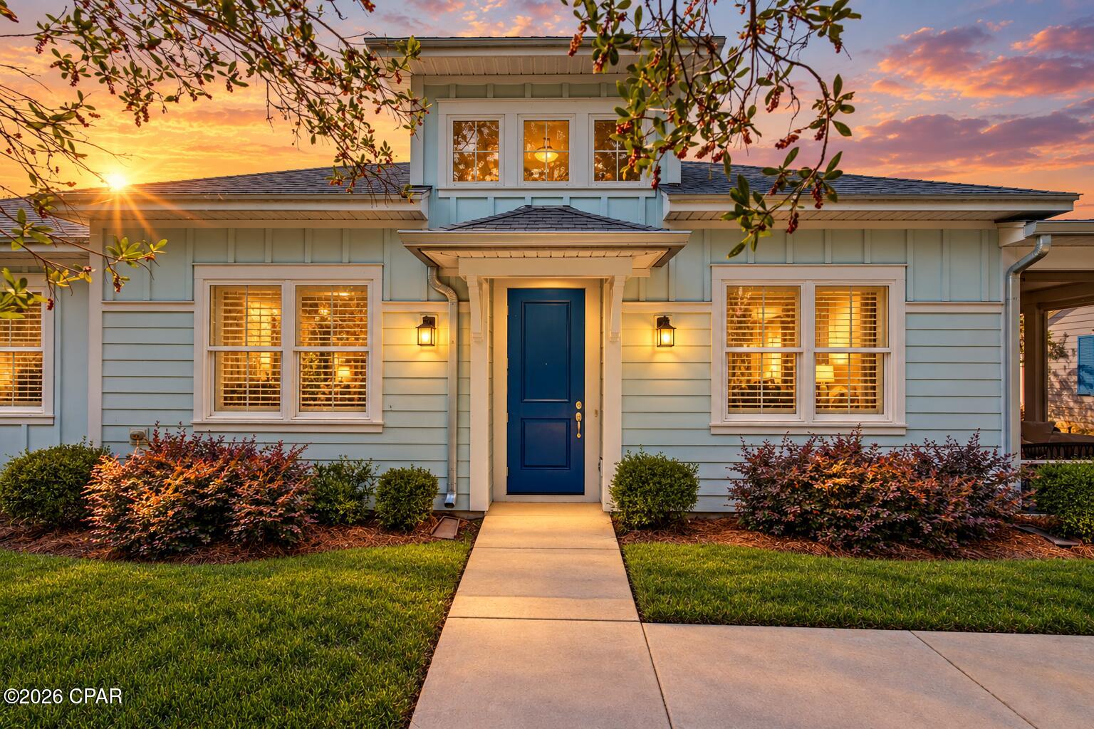 The lights come up. The front door opens. And suddenly, the life you have been working toward has a setting.
Welcome to 8497 Dreams Float Court, an Aloha Cottage at Latitude Margaritaville Watersound with a personality all its own.  With over a $100K in builder selected upgrades this Aloha has it all! Step inside and your eyes travel upward to the vaulted ceiling and painted beams, then across the custom wall details and warm, inviting living space. Plantation shutters frame the windows. Designer lighting sets the mood. In ceiling speakers are ready when the moment calls for a soundtrack.
At the center of it all is a kitchen built for the people who love to entertain. The extended island gives them room to gather while quartz countertops and a full height quartz backsplash make the entire space shine. Upgraded cabinetry, crown molding, pullout shelves and a double trash pullout bring thoughtfulness to every inch. Picture the first cup of coffee before the day begins. Then picture friends around that same island long after dinner was supposed to end.
The evening moves to the screened porch. The ceiling fan turns overhead, the conversation carries on, and nobody is checking the time. When the last guest leaves, the home becomes your retreat again. The primary bath welcomes you with a rain shower, tile reaching the ceiling, a seamless glass enclosure and quartz countertops. It is the kind of room that makes an ordinary Tuesday feel like an occasion.
Throughout the home, upgraded tile flooring, crown molding, recessed lighting and carefully chosen finishes tell the same story: every detail was considered. Even the garage plays its part, with an epoxy floor, insulation and a utility sink.
Some homes are a stop along the way. This one feels like the moment the music swells, the doors open, and you realize the best part of the story is just beginning.