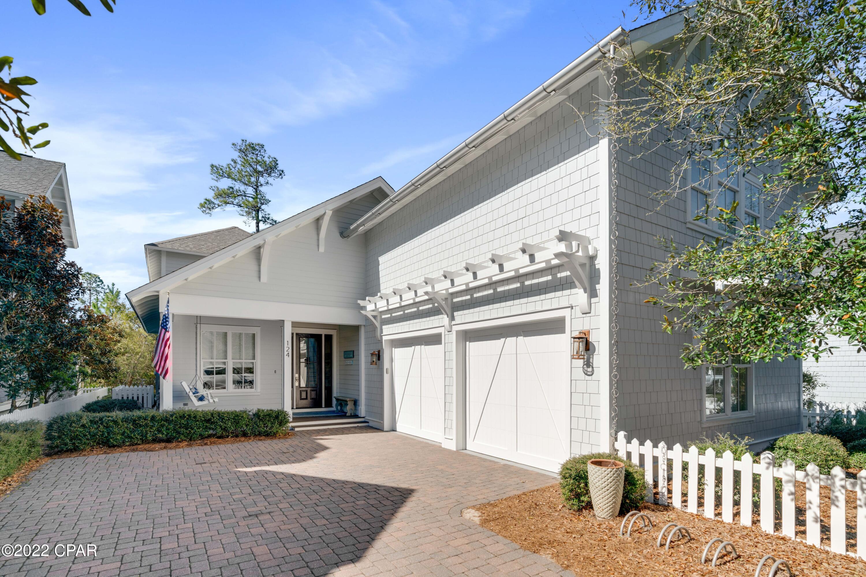 Experience the luxury of being south of 30A in this Nantucket-inspired home within WaterSound. A true coastal retreat with modern elegances can be found in this 5 bedroom, 5.5 bath home that is skillfully-designed with exquisite attention to detail. Whether you're looking for a private retreat or a home for entertainment, the privacy this home offers along the lakeside is unmatched. The oversized screened porches span the entire length of the home on the main level and the upper level, as well, taking full advantage of the lush natural landscaping and views. Entertain outdoors with your summer kitchen including a gas grill with custom hood or take in the sea breezes and serenity as you relax outdoors lakeside on the swinging beds and cozy furnishings. Complete with hardwood flooring, custom woodwork, crown molding, tongue and groove walls and a gas fireplace with built-in bench seating, no detail was overlooked in this beachside masterpiece. A convenient, main level master suite becomes a true sanctuary with a separate sitting room, spacious bath to include a clawfoot tub and a large shower along with French doors to the screened porch to enjoy the peaceful lakeside views. Three additional bedrooms on the upper level offer guests their own private hideaway with all ensuites and two bedrooms with screened porch access. A spacious loft on the upper level is perfect for an additional living area that guests can enjoy when visiting the beach. The carriage house is access by a second staircase within the main home and provides vaulted ceilings, a kitchenette, living area, bathroom, large closets and the privacy your guests desire but still being connected.

WaterSound West Beach offers an incredible community pool and clubhouse with private beach access, to include access to all WaterSound Beach amenities within the main gates of WaterSound. This highly sought-after gated community is perfectly positioned adjacent to Deer Lake State Park and between The Hub and Seagrove making it ideal for a secondary home, investment rental property or a primary residence.