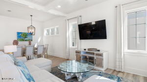 HIGHLY MOTIVATED SELLER!! PRICED 100'S OF THOUSANDS BELOW MARKET VALUE!!! This unbelievable price on this beachfront dream home, fully professionally decorated and being SOLD FULLY FURNISHED, is ready for your family right now. The home is the very best Panama City Beach has to offer not just because of its stunning beach sunsets that can be enjoyed over three expansive gulf front balconies, this home is located in the luxurious Margaritaville Cottages Resort.Tropical pools with bar service, water slides and lazy river for the kids, and nothing short of white glove service. This home features its own gulf front private pool and beach walkover. Modern day amenities of this home allow for multiple generations to enjoy the beachlife, featuring a private elevator going all the way up to the third floor. Just off the pool on the first level is a great room complete with a wet bar, ice machine, full size refrigerator and a large sitting area with lots of seating, big screen tv and a foosball table. Located on this level is also a full size bathroom and bedroom. For the most stunning views of the beach this home features its living and entertaining space on the second floor. Opening up to an expansive balcony is an open concept that allows everyone to enjoy, whether you're relaxing in the deep sectional sofa, having a bite at the dining table or showing off your chef skills in the kitchen for the week featuring fresh gulf seafood, you will be sure to have a stunning view of the emerald coast's sparkling water and white sandy beach. For the chef in the family, this kitchen is sure to not disappoint, featuring Frigidaire Professional Appliances, 36'' gas range, quartz countertops, and exquisite cabinetry. In addition to the living and entertaining space on the second level, the home also features two guest bedrooms with ensuite baths and a full size washer and dryer along with a half bath. Next on the third floor is the beachfront master suite with sweeping gulf views running east to west. Stepping out on the expansive third floor balcony allows its guest to see all the way down the panhandle's coast line. Getting ready for your day or unwinding is nothing short of luxury in the exquisite master bath, featuring a massive oversized glassed-in shower with stunning tiles and a walk-in closet. The 3rd floor also includes two additional guest bedrooms with ensuite baths, as well as another bunk area. Plenty of parking with a two-car carport, as well as three additional spaces. Owners and guests will experience the ultimate in island-inspired dining and drink options with Margaritaville's signature concepts, including The Salty Rim Bar & Grill Fins Restaurant and Bar, and Joe Merchant's Coffee & Provisions.Unwind in the expansive resort oasis pool, complete with private cabanas, H20 Adventure Waterslides, and a 425-foot lazy river. Engage in a friendly game of pickleball, participate in activities on the lawn, or test your skills in the indoor arcade. At Margaritaville, they cater to every preference. If relaxation is your goal, soak up the sun on the beach. If adventure is your calling, try the bike rentals or paddleboard lessons. With options to suit every itinerary, Margaritaville promises an unforgettable beach experience. Call today for additional information on the resort, rental income potential and to see this beautiful beachfront home.