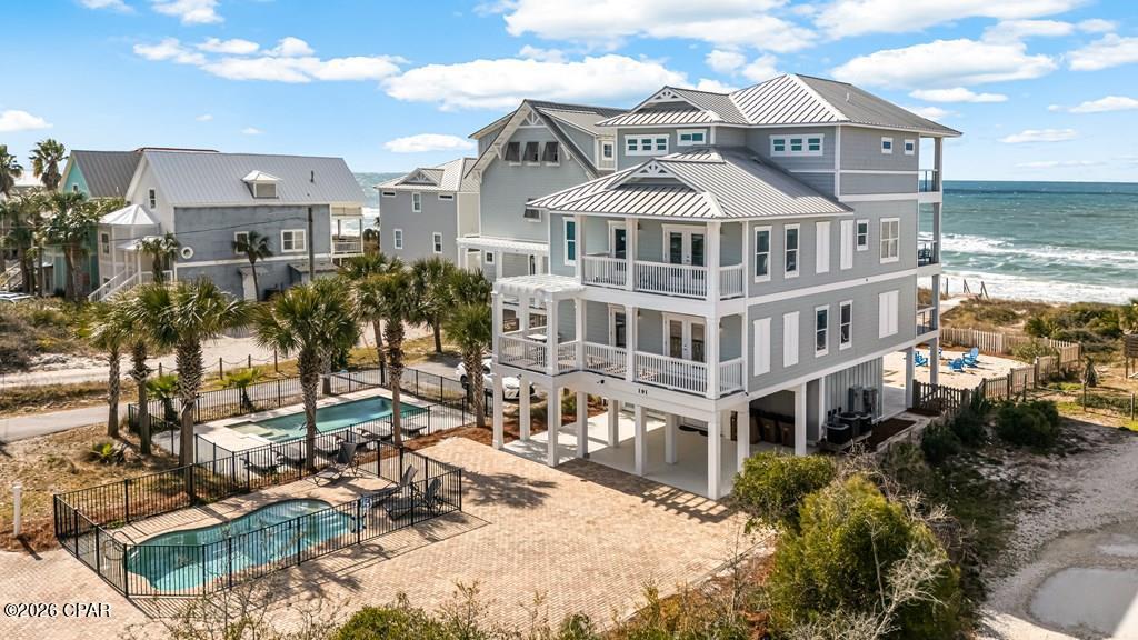 GULF FRONT, NORTH CAPE CUSTOM BUILT HOME WITH PRIVATE POOL AND ELEVATOR. This 6 bedroom, 5 bathroom retreat sits directly on the beach, offering wide-open Gulf views & the kind of tranquility buyers come to the Cape for. The main living level is filled w/ natural light, highlighted by coastal shiplap accents & an open layout made for gathering. The beautiful kitchen combines style & function with top-of-the-line appliances, Carrara marble countertops & an oversized pantry. A guest bedroom with balcony access & a well-appointed half bath complete this level. The top-floor primary suite offers exceptional privacy & a peaceful escape featuring marble-topped vanities, a soaking tub, spa-style walk-in shower & a private balcony overlooking the water. Coastal breezes and sweeping views create the perfect place to unwind. The first level offers additional living & entertainment space, two Gulf-front bedroom suites & a bunk room, ideal for hosting family & guests. An elevator serves all floors for convenience. Outdoor living is just as impressive, with a firepit, a covered patio & a fenced private pool designed for lounging & poolside gatherings. Additional features include private boardwalk beach access, a fire pit area, outdoor shower & full bath, fish-cleaning station, irrigation system, lockable owner's closets & smart under-stair storage. Recent upgrades provide peace of mind, including new furnishings, three new HVAC units, fresh exterior paint, replaced doors, new fencing, under-decking & a gravel yard to maximize outdoor enjoyment & privacy. Located in one of the Cape's most desirable settings w/ no HOA, this home offers miles of pet-friendly white sand beaches, paved biking & walking paths, kayaking, fishing, local shops & dining, with St. Joseph Peninsula State Park, named number 1 beach in America, just minutes away. Already a successful, professionally managed vacation rental, this property offers both exceptional lifestyle enjoyment & proven income potential.
