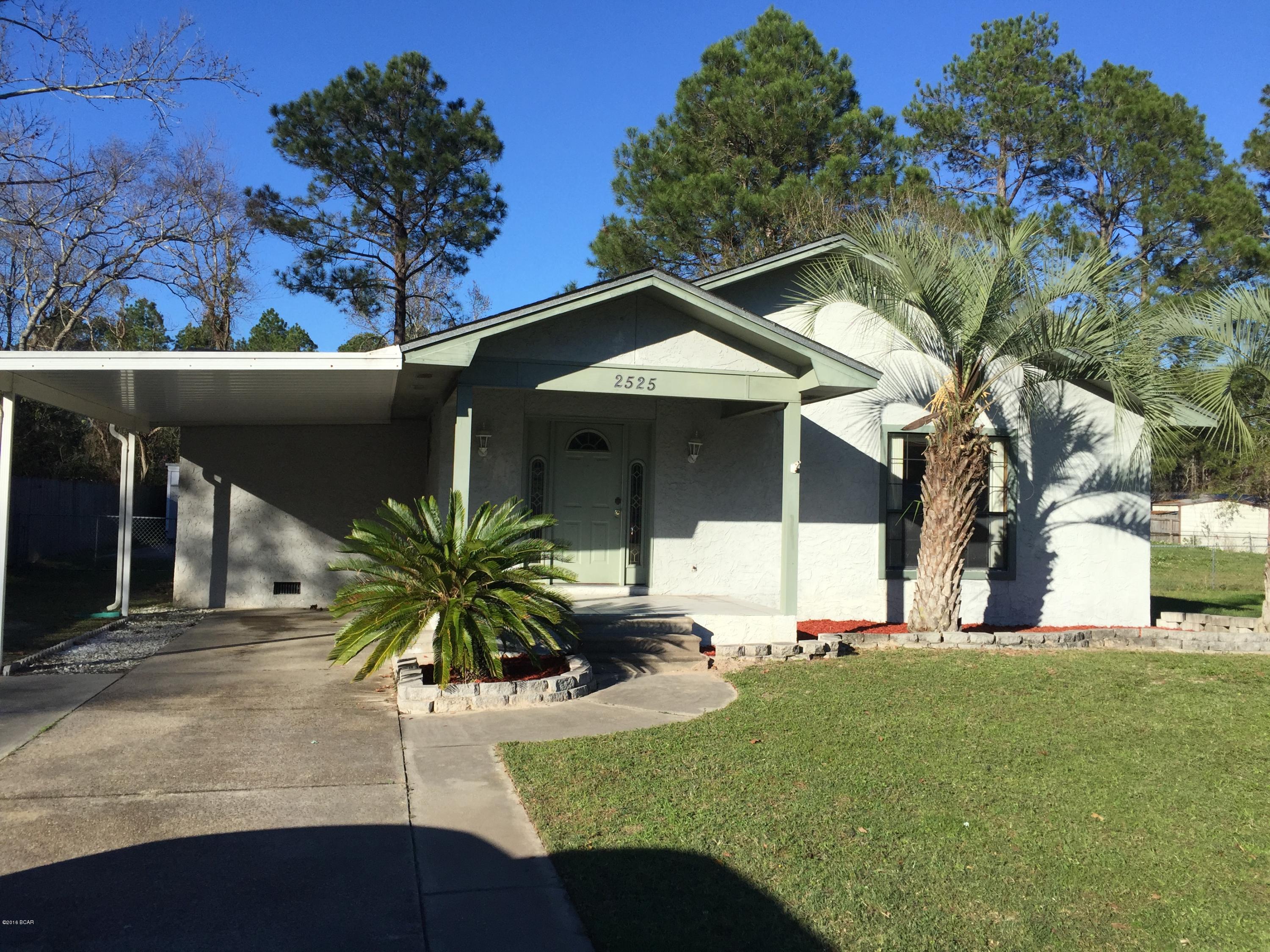 This split floor plan home presents well. Nice contemporary home with a huge living room complimented by very tall ceilings and illuminated with plenty of light. The open kitchen and dining area are only separated by a breakfast bar. The abundant cabinets and countertop appear to be updated and are in great shape.  There is a spacious screened in porch, two yard buildings, and a fenced in backyard. The large utility room has space for a washer and dryer with plenty of room left over for storage or a workshop.