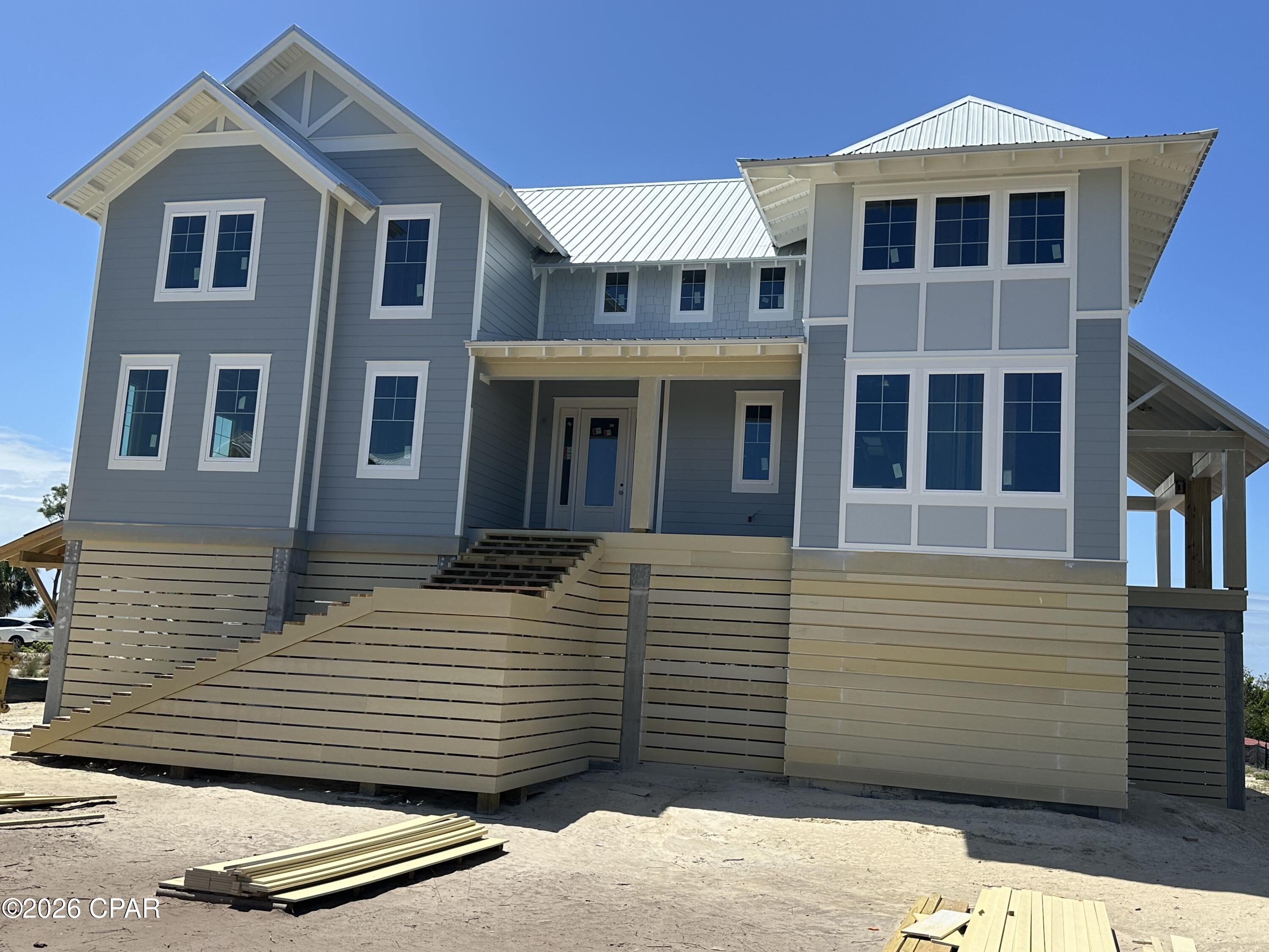 Nestled in the gated community of WindMark Beach, this exceptional new construction home is being built by highly regarded Bonavic Construction. The open floor plan blends refined coastal style with everyday comfort while capturing views on every floor..  The Great Room features a gas fireplace and opens to a wrap-around balcony for seamless indoor-outdoor living. A spacious screened-in 'Sun Room' with a second gas fireplace offers year-round enjoyment, while preserved view corridors showcase sunrise over the Preserve, bay sunsets, and Gulf Coast stargazing.  The home offers four private en-suite bedrooms, a modern kitchen with oversized island,  beverage bar, and a serene Primary Suite with cathedral ceilings and private lounge. The ground level includes a three-car garage with generous storage and elevator access to all floors.  Construction should be complete in July.  Floor plans and a design for a walk-out pool are available.    WindMark Beach provides deeded beach access, a clubhouse, community pool, scenic trails, boardwalks, and a true golf-cart lifestyle—perfect for full-time living, a vacation retreat, or investment.