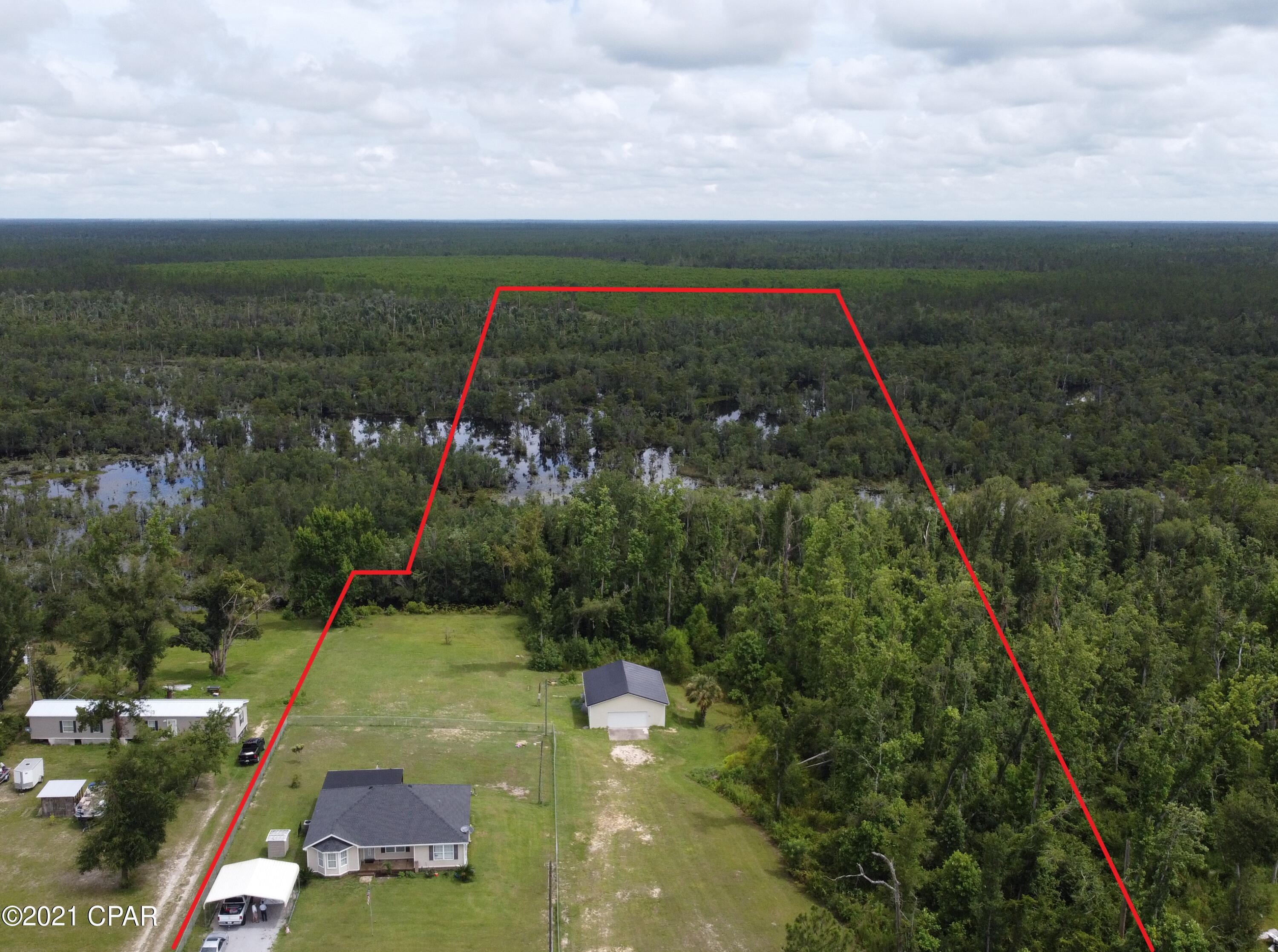 LET THE GOOD TIMES BEGIN!! A SPECTACULAR CUSTOM BUILD, 7.9 ACRES, AND WATER ACCESS TO DEERPOINT LAKE. This spacious open concept home boasts the perfect blend of privacy and proximity. Enter into a main living space with with stunning wood floors. A beautiful kitchen with plenty of nice cabinetry, a pantry, and a window right above the kitchen sink for viewing the back yard while working in the kitchen. Open dining space with plenty of room. Split bedroom floor plan features a spacious master bedroom with en suite that offers his and her sinks, shower, tub, and walk in closet. Nice sized guest rooms and one has direct bathroom access. A covered front porch and a huge covered back porch is great for enjoying the mornings, evenings, or for entertaining. The 29X35 detached garage makes a great place to store all of the toys. The detached garage has its own separate electrical meter and has a 30 amp RV connection on the power pole. Morganville Rd is a quiet dead end street. A portion of the yard is completely fenced for keeping the little ones or fur babies safe. Not to far out, you can be in town in about 15 minutes but yet far enough to enjoy peace and serenity.