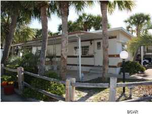 Check out this fantastic deal in Venture Out. This would be great as a vacation home, building site or investment opportunity. This home features a great covered patio and beautiful lot. Venture Out boasts 300' of the Gulf and 1,000 ft. on the Grand Lagoon. It also has 2 saltwater pools, putt putt, fishing dock, boat launch and children's play ground. This is a family friendly golf cart community with 24 hour security.