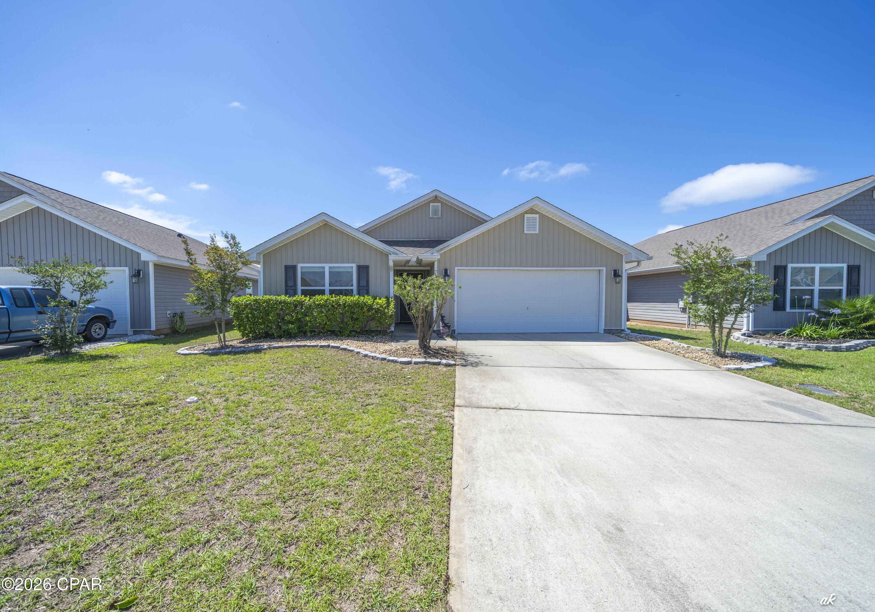 **OPEN HOUSE SATURDAY, JUNE 27TH, 2026 FROM 2PM TO 4PM**  Welcome to this beautifully maintained 4-bedroom, 2-bath home at 7138 Hatteras Boulevard in the desirable Barrett's Park community, just north of Panama City. Combining modern features with everyday comfort, this home is move-in ready and designed for easy living. Step inside to an inviting open floor plan with durable laminate flooring flowing seamlessly throughout the entire home. The spacious living area is anchored by a stylish electric fireplace, creating the perfect focal point for relaxing evenings or entertaining guests. The kitchen and dining areas connect effortlessly, offering plenty of space for gatherings and daily life. The primary suite provides a comfortable retreat with multiple closets and double vanity sinks, while three additional bedrooms offer flexibility for family, guests, or a home office setup. Enjoy outdoor living year-round on the screened-in porch, complete with a hot tub--ideal for unwinding after a long day. Additional features include attic storage for extra space and the convenience of an included washer and dryer. There is a shallow well that is connected to irrigation so you can keep your lawn green all summer without the additional costs of metered water. Energy efficiency is a major bonus with solar panels that will be fully paid off at closing, giving you long-term savings and peace of mind. Located just minutes from shopping, dining, and the beautiful Emerald Coast beaches, this home offers both comfort and convenience in a growing area. Don't miss your chance to own this fantastic home--schedule your showing today!
