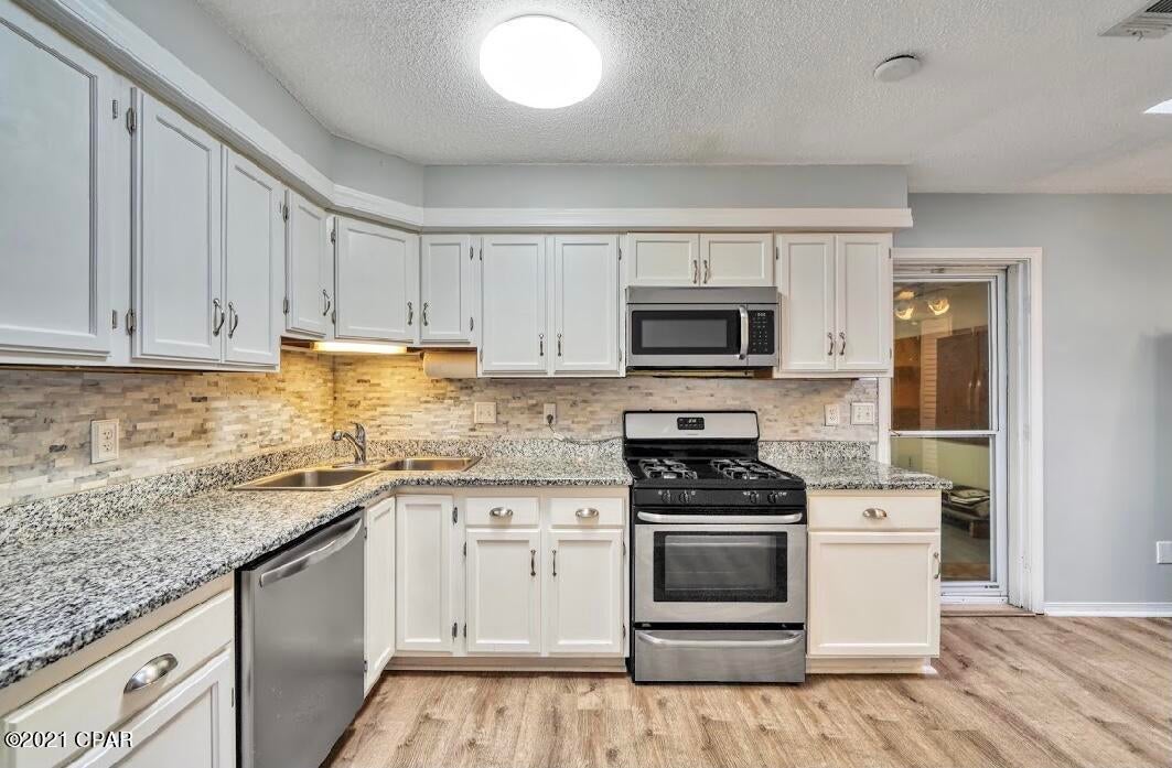 Rare opportunity to own a single family home with a private pool near the Northshore area. Home has been updated featuring new kitchen cabinets, granite countertops and SS appliances, new bathrooms with subway tile, new shower glass doors and vanities with quartz countertops. LBP flooring for easy maintenance, freshly painted. Enclosed Back porch has heating/AC so can be enjoyed year round. Fenced Back yard with salt water pool, jetted spa, different seating areas, side patio and a gazebo. Move in ready! 

Roof replaced in 2018.

Convenient location near Lynn Haven, shopping, dining, medical care all within 15 minutes to the college, the Beach and Tyndall.

Measurements are approximate, please verify all if importa
