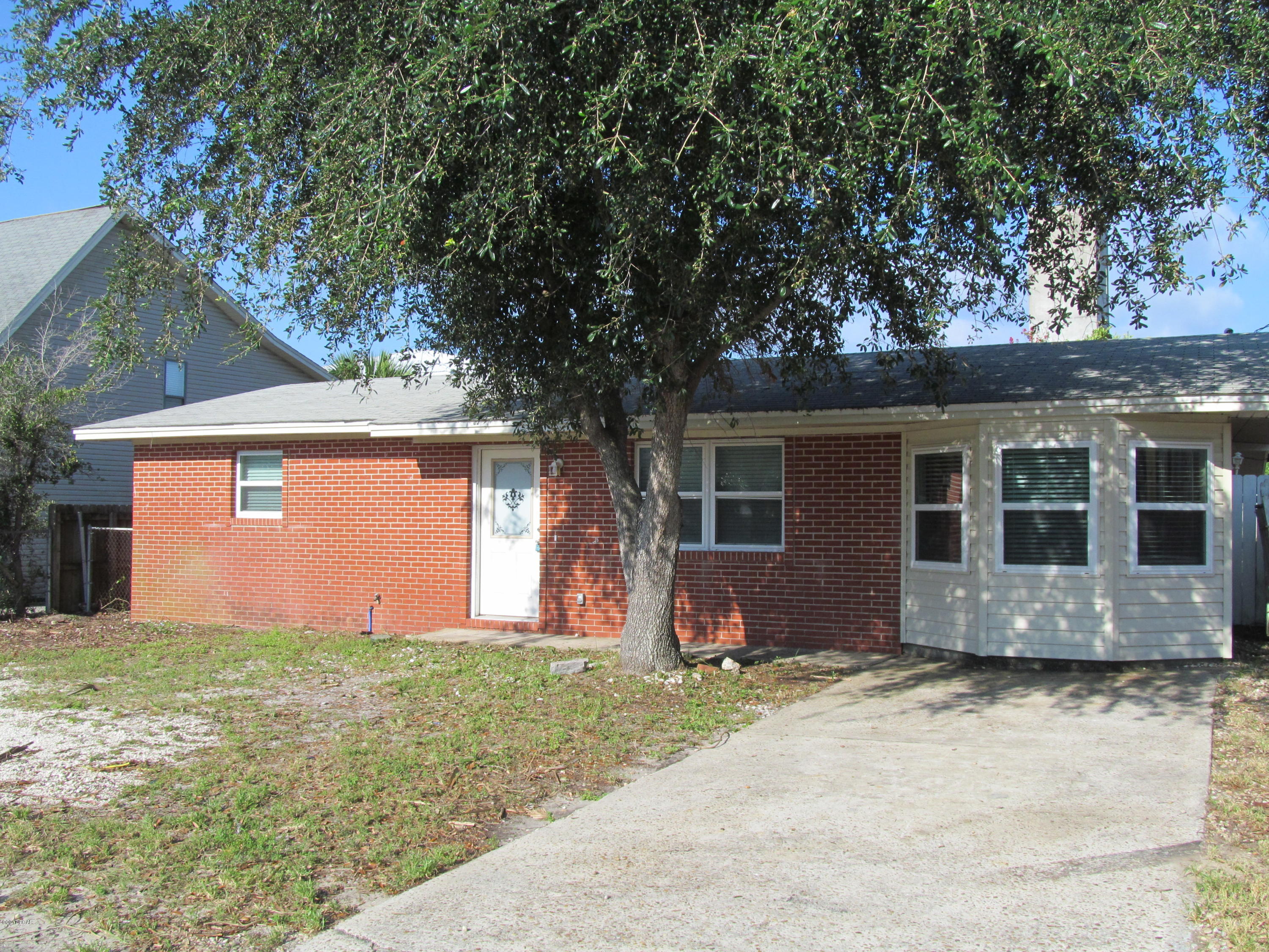 2 bedroom, 1 bath home features living and family rooms, open kitchen and screened patio off back. New carpet in bedrooms. Conveniently located within walking distance to the beach. ! dog under 25 lbs - $250 deposit & $50 pet fee.