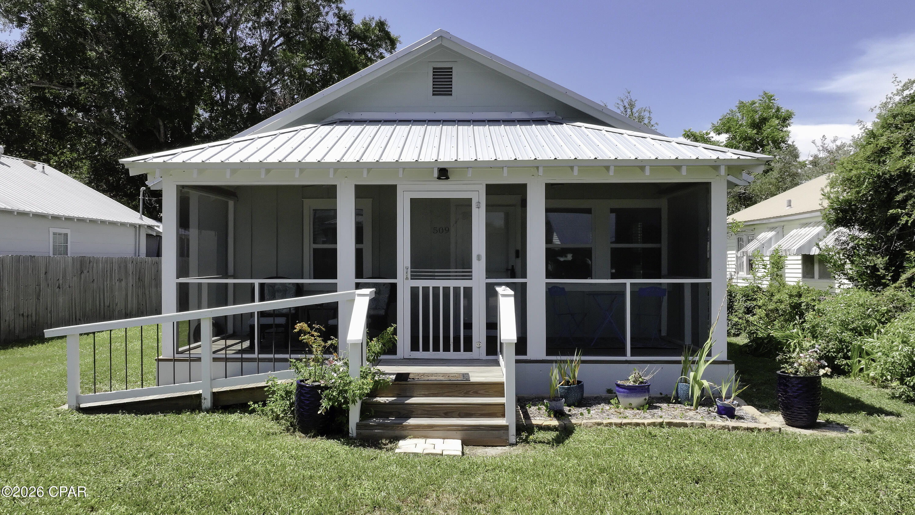 Turnkey Investment Opportunity with Two Short-Term Rental Eligible Homes! Seller financing available. Whether you're looking to expand your investment portfolio, own a vacation getaway with income potential, or enjoy multi-generational living, this unique property delivers. Situated on a generous 0.20-acre lot just a short golf cart ride from downtown, this offering includes a beautifully renovated 2BR/2BA main home (1,254 SF) and a separate 2BR/1BA accessory dwelling (660 SF)--both eligible for short-term rentals.  Both homes have been thoughtfully updated and are offered completely furnished, making this a true turnkey opportunity. Recent improvements include a new metal roof, new flooring, updated interiors, modern kitchens, and refreshed bathrooms. The main home features an inviting covered front porch, an open-concept living area, abundant natural light, and a stylish kitchen with stone countertops, gray cabinetry, stainless appliances, and a center island perfect for entertaining.  The detached accessory dwelling provides exceptional flexibility for guests, extended family, or additional rental income. A privacy fence separates the two residences, allowing each home to enjoy its own space.  With multiple parking spaces, bay views from the road, and strong income-producing potential, this property is ideal for investors, second-home buyers, or owner-occupants who want to live in one home while generating income from the other. Rare opportunities like this don't come along often.