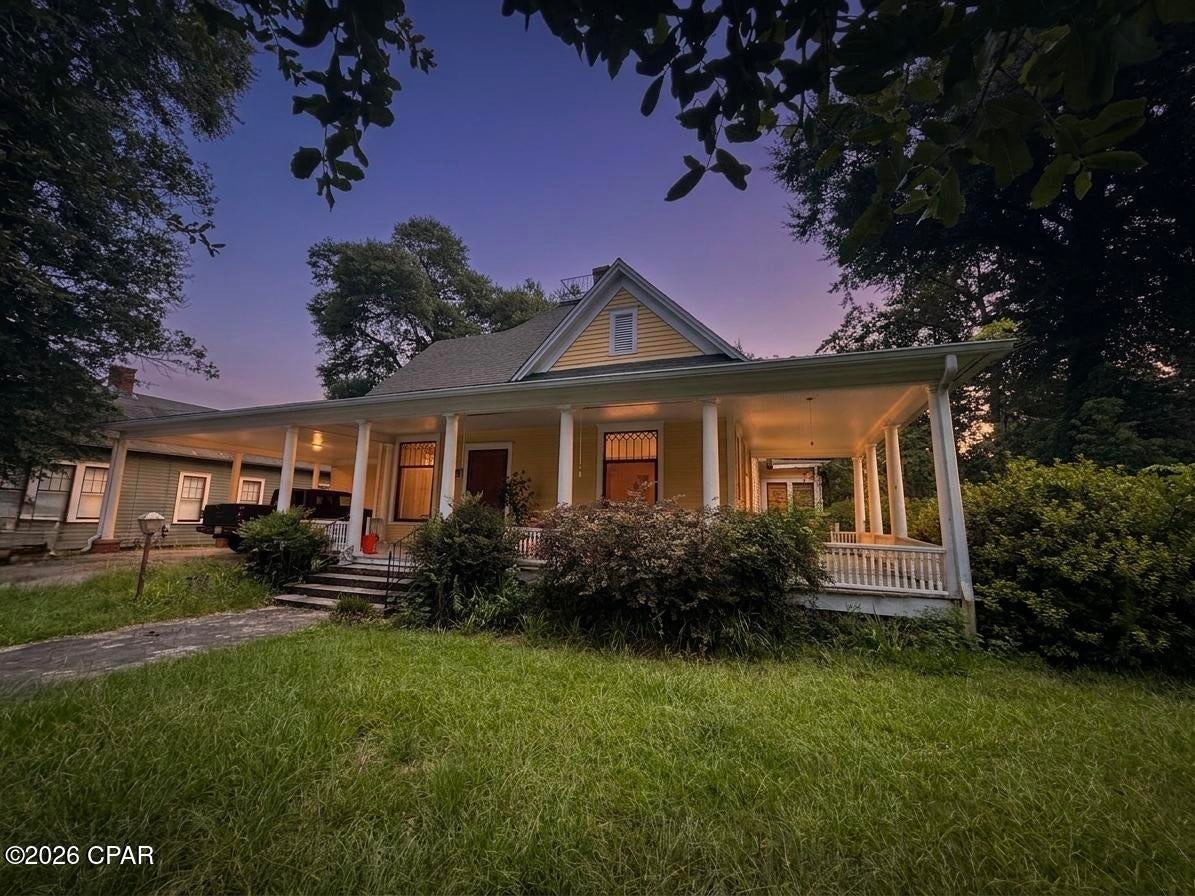 Timeless Victorian Charm in the Heart of Downtown Marianna! Nestled beneath a canopy of majestic oak trees on one of Marianna's most picturesque streets, this classic 2-bedroom, 2-bath Victorian is brimming with character and opportunity. From the inviting wraparound Southern front porch to the expansive screened porch stretching the entire length of the home, you'll find countless spaces to relax and enjoy the beauty of historic downtown living.

Step inside to discover oversized living areas filled with natural light, soaring ceilings, and original hardwood floors that flow through nearly the entire home. Multiple decorative fireplace surrounds add warmth and architectural charm, creating the perfect backdrop for restoring this historic beauty to its full potential.

The attached carport provides everyday convenience, while the deep lot extends all the way through to Jefferson Street, offering exceptional accessibility and flexibility. Zoned Mixed Use, the property opens the door to a variety of residential, office, or investment possibilities (subject to local regulations).

Whether you're dreaming of restoring a grand historic residence, creating a charming bed and breakfast, establishing a professional office, or investing in one of downtown Marianna's most distinctive properties, this Victorian is ready for your vision. Homes with this much history, charm, and potential rarely come available--don't miss the chance to bring this Southern treasure into its next chapter.
Cash or conventional buyers only. 
Water heater replaced 2026