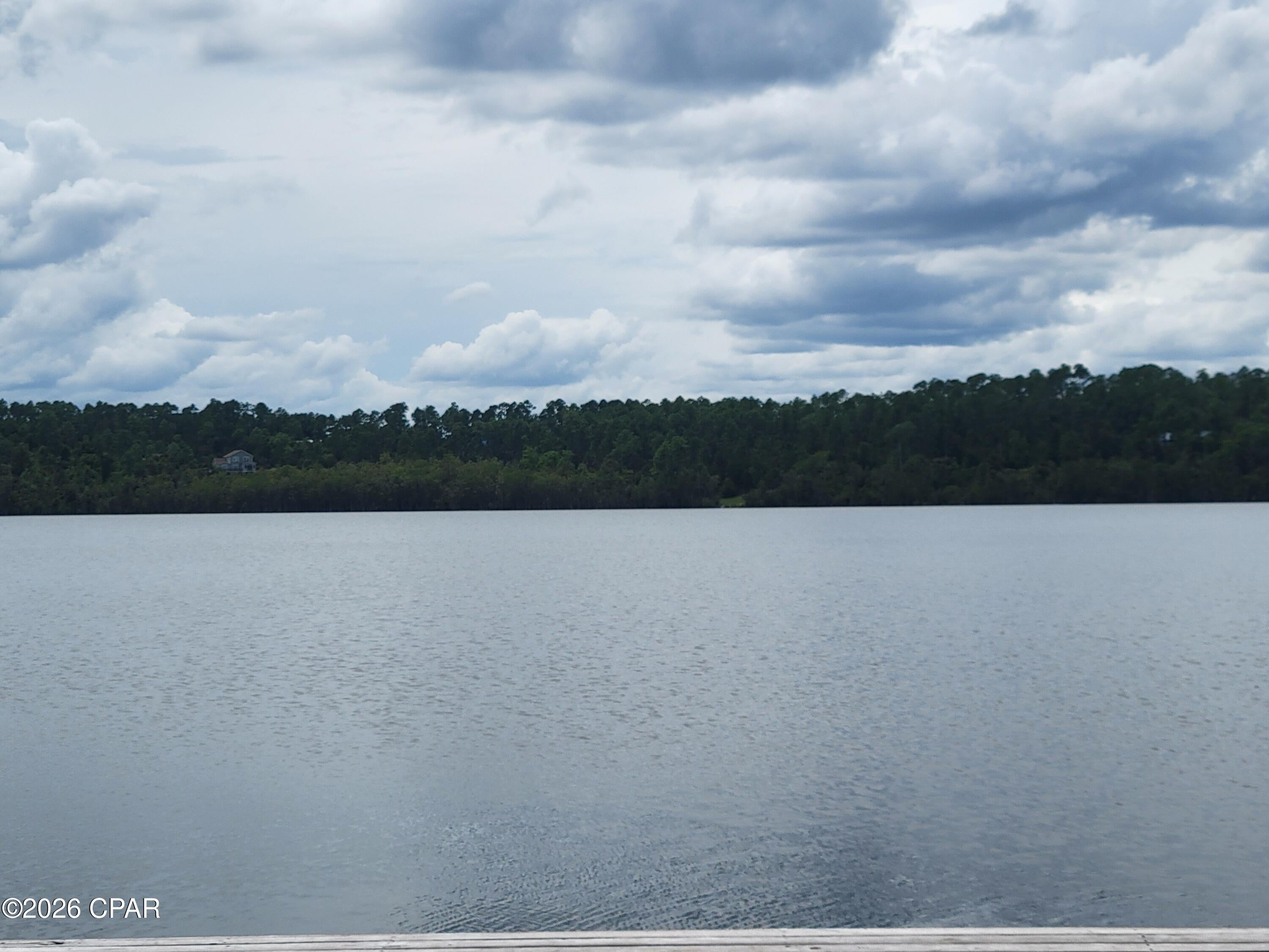 Rare opportunity to own approximately 1+/- acre of WATERFRONT property on beautiful McCormick Lake! Whether you're looking for the perfect spot to build your dream home, a peaceful weekend getaway, or simply a place to enjoy the outdoors, this property offers a wonderful combination of privacy, natural beauty, and lakefront living.

Imagine waking up to peaceful water views and spending your days fishing, kayaking, swimming, or simply relaxing along the shoreline. McCormick Lake is a private, serene lake where gasoline-powered motors are not permitted, helping preserve the quiet atmosphere and natural beauty of the area. Electric motors are allowed, making it a great lake for fishing and leisurely days on the water.

Property owners also have access to the McCormick Lake Recreation Area and its many amenities, including a beautiful beach and swimming area, dock, boat ramp, clubhouse, picnic areas, and large and small covered pavilions. Fishing boats, fun yaks, and other water toys are also available for rent. The clubhouse can be rented for family gatherings, reunions, parties, weddings, and other special occasions.

Enjoy abundant wildlife, peaceful surroundings, and the laid-back North Florida lifestyle while still being within driving distance of Marianna, Panama City, and the beautiful Gulf Coast. Waterfront lots like this don't come along every day--come take a look and imagine the possibilities!