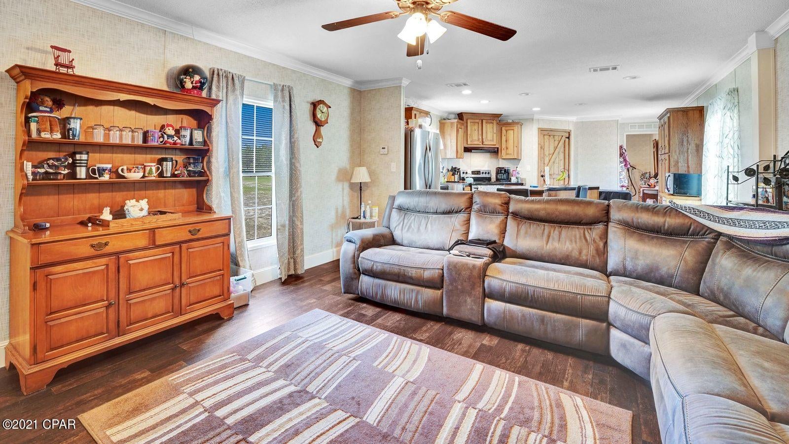 CURRENTLY UNDER CONTRACT, SELLER ACCEPTING BACKUP OFFERS Almost brand new single wide on an acre of land. 2019 home with stainless appliances, wood cabinets, and LVP flooring. AC is new from 2019. Water heater new from 2019. The kitchen features a stainless steel farm house style sink and a custom ''Z'' island.  Crown molding through out home. Recessed lighting and plenty of storage space. Nicely appointed lighting and ceiling fans throughout the home. Master has a walk in closet.  The master bathroom has a double vanity and nice walk-in tiled shower. The home was a custom design and is 16'x80'. The acre of land is upkept and includes two storage sheds that convey with sale. Measurements are approx. and should be verified if important.