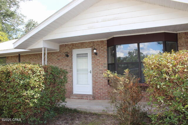 Charming 3BR/2.5BA brick ranch situated on a 1.15-acre corner lot just across the street from the scenic Chipola River! Don't worry across from the River but not in a Flood zone, no flood insurance needed! Located in a quiet subdivision with access to two private boat launches, this property is perfect for outdoor enthusiasts. The partially fenced yard is a fruit lover's dream—featuring mature blueberries, satsumas, persimmons, calamondin, figs, grapes, Japanese plum, pear, and pecan trees. For the fisherman there's a Catawba tree.  Easy access for parking your RV or boat, with a detached carport and two large workshop/storage buildings included. Recent updates in 2025 include quartz countertops, new sink, cabinet hardware, refinished cabinets, new stove and dishwasher, fresh interior paint, new water heater Nov 2025, and luxury plank flooring. Basement offers additional storage space, and the floor & walls were just recently painted in Nov 2025.  This home does have a Metal roof installed June 2015, and a radiant barrier was included in the attic in 2014 to help with the heating & cooling. Ideal location for those working at the new Calhoun Liberty Hospital. Move-in ready and packed with potential!