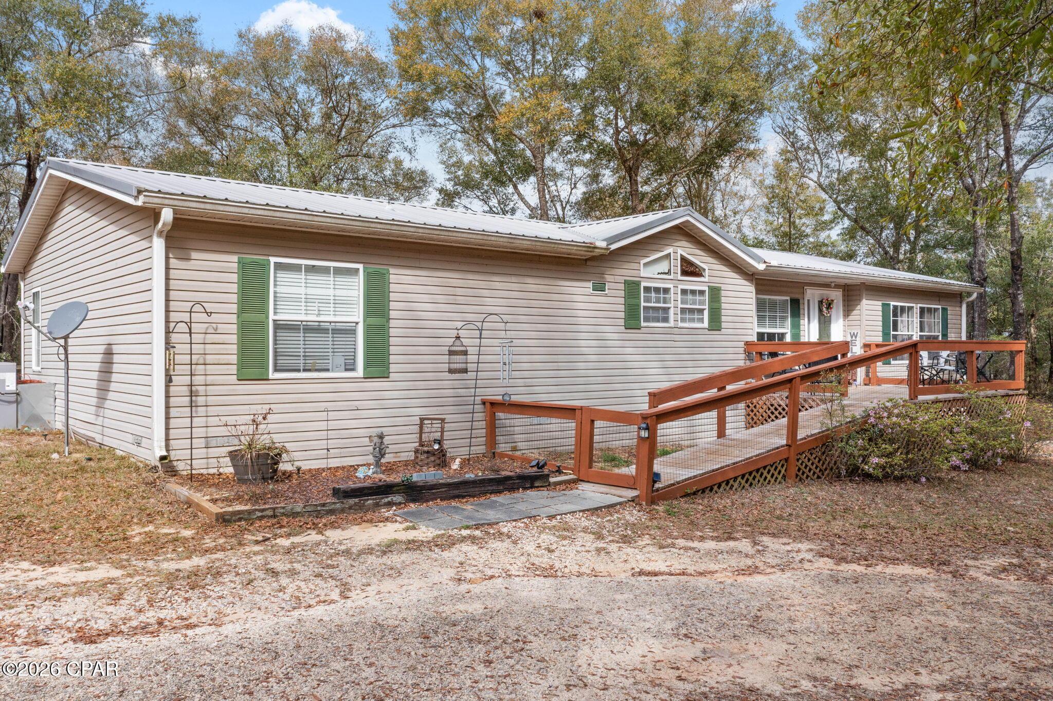 Discover the perfect blend of country charm in this beautifully maintained 3-bedroom, 2-bathroom spacious double wide mobile home. Nestled in the desirable Leisure Lakes community, this property offers a unique close by opportunity to enjoy the world-famous white sand beaches of the Gulf Coast while retreating to your own private, tranquil countryside setting.

Leisure Lakes is a private, gated community centered around two pristine lakes, offering a host of exceptional amenities for a relaxed lifestyle. Residents enjoy access to:
*   Community Lakes with white sand beaches for swimming and sunbathing
*   Boat Ramp for easy access to the water
*   Sparkling Community Pool
*   Tennis Courts
*   Picnic Pavillion for gatherings
*   24/7 Security Gate for peace of mind

The home itself is situated on a sprawling two-acre wooded corner lot, providing immense privacy and space. The long driveway sets the home back from the road, ensuring a quiet and peaceful environment. There is plenty of room for a garden and for your pets to run.

Inside, you'll find a well-designed and spacious layout:
*   Split Bedroom Floor Plan offering privacy for the master suite.
*   Large Open-Concept Living Room and Kitchen, ideal for entertaining and family life.
*   Generously Sized Bedrooms with ample closet space.
*   Luxurious Master Bathroom featuring a large whirlpool tub and a separate walk-in shower.
*   Chef's Kitchen complete with a central island, breakfast bar, and plenty of room for meal preparation.


Outside you can sip coffee or your favorite beverage from you front porch with an added handicap ramp feature


Updates include a metal roof, front porch with a handicap ramp, hvac, and gutters w/leaf guards.


This is country living at its best. A place where you can enjoy the serenity of nature on your own expansive lot while being just a short drive from the coast. Don't miss your chance to own this incredible property.


Schedule your private showing today!