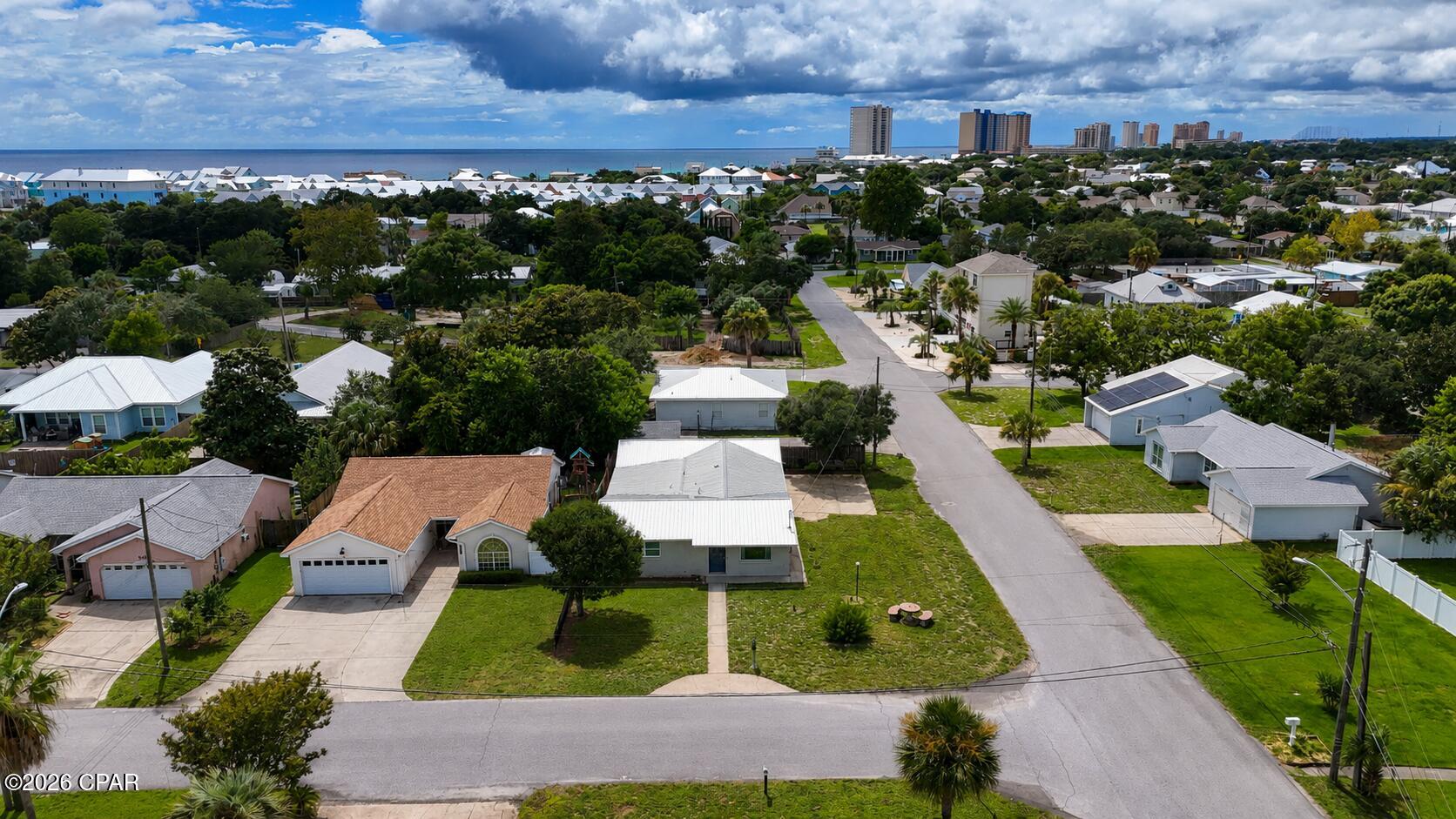 Major Price Reduction! Motivated Seller! 

Welcome to this charming 3-bedroom, 2-bath beach cottage situated on a spacious corner lot in a quiet, family-friendly neighborhood just minutes from the Gulf. Full of classic Old Florida charm, this home showcases original terrazzo floors and vintage tile while offering numerous modern updates, including newer appliances, HVAC system, water heater, doors, windows, crown molding, and an attractive metal roof. The kitchen is highlighted by a stunning custom stained-glass window that creates a warm and inviting focal point. A versatile sunroom provides the perfect space for a home office, playroom, guest room, or additional living area to fit your lifestyle. Just off the garage, the unfinished 3rd bedroom offers endless possibilities as a workshop, craft room, hobby space, or storage. Located in a desirable neighborhood with no short-term rentals, you'll enjoy a peaceful setting while remaining close to everything Panama City Beach has to offer. The home is conveniently located near Hutchison Beach Elementary School, Surfside Middle School and Arnold High making it an excellent choice for families. You'll also have quick access to Hutchison Boulevard and Panama City Beach Parkway, placing Pier Park, Dolly Parton's Pirates Voyage Dinner & Show, Topgolf, shopping, dining, and entertainment just minutes away. Best of all, you're only 0.5 miles from the sugar-white sands and emerald waters of the Gulf of Mexico. Whether you're looking for a primary residence, second home, or beach retreat, this property offers the perfect blend of charm, location, and flexibility. Schedule your private showing today! All measurements, dimensions, and information are approximate and should be verified by the buyer if important.