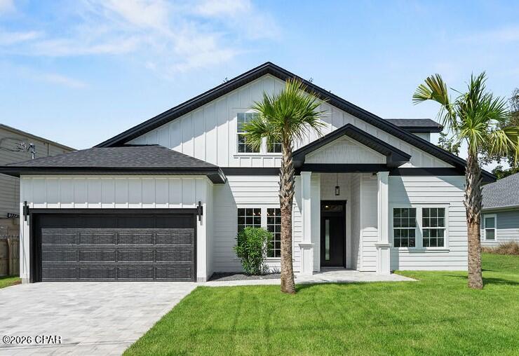 Welcome to this beautiful 2026 custom-built 1.5-story home in Panama City Beach, offering 4 bedrooms, 2.5 bathrooms, and a functional floor plan. The first floor features the primary bedroom, a second bedroom that can be used as a guest room, office, or flex space, and a convenient half bathroom. Two additional bedrooms, a full bathroom, and a living area are located on the second floor, providing flexibility and privacy.

The main living space features an open-concept kitchen, dining, and living area. The kitchen includes a large pantry and a dedicated laundry room. Additional features include a large back porch, 2-car garage and a large driveway providing ample parking.

The back porch includes an outdoor kitchen, offering an additional space for outdoor dining and entertaining.
Located on Heather Drive with convenient access to West Highway 98, the property is less than half a mile from the sandy beach. The home is also a short drive from TOC Panama City Beach, Inlet Beach and nearby restaurants, shopping, entertainment, and recreational amenities throughout Panama City Beach and the surrounding coastal area.