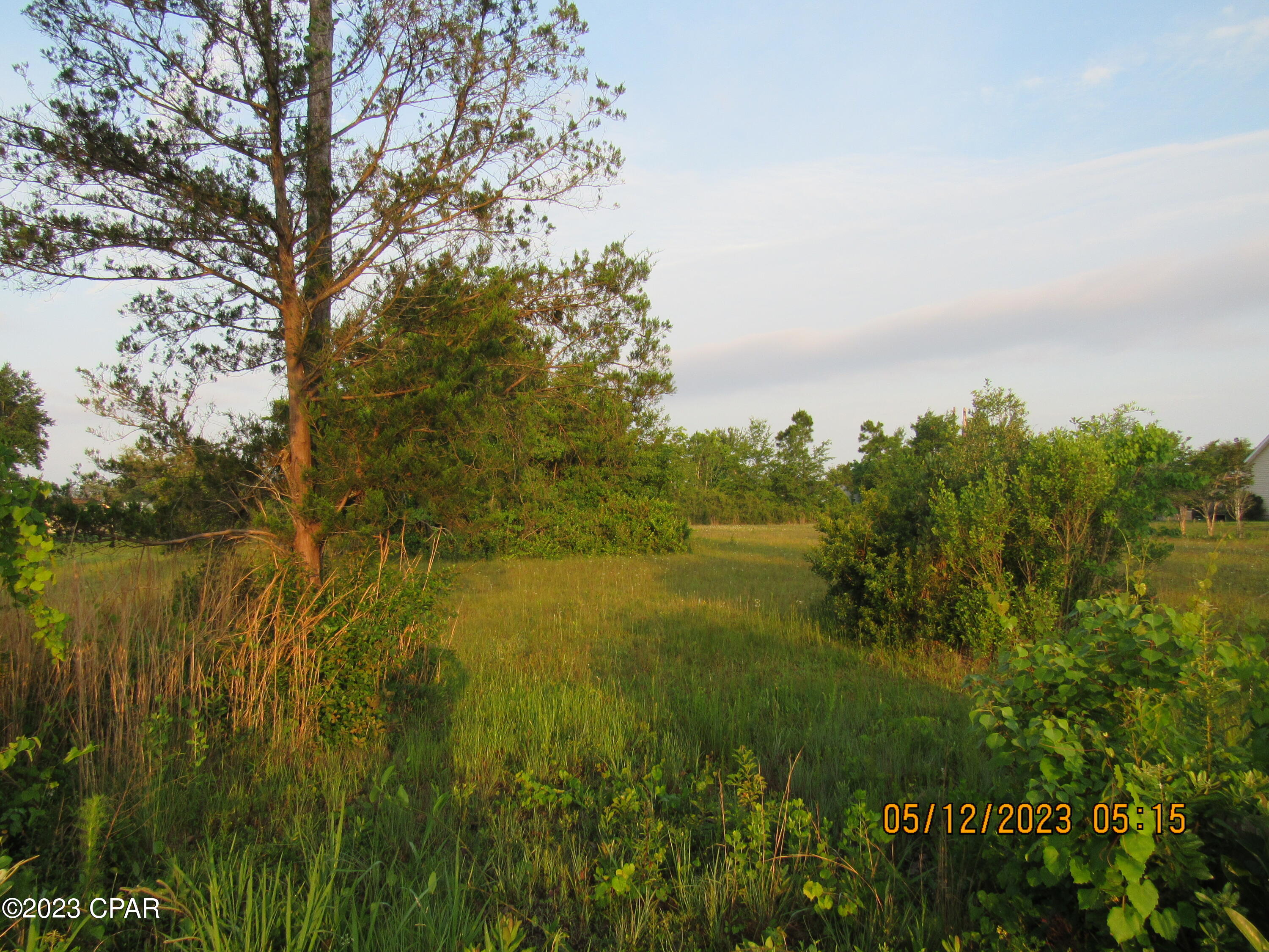 Perfect Building Parcel. This 1.03 acres is a GREAT property to get away from the city and expand your country vibe. With no HOA . Public water and sewer are available along with electric. You get the peace of living in the country and  Entertainment, Fine Dining and Fun of being only minutes away from Panama City. Just a little further and you HIT THE BEACH on the Sugar White Sands of Panama City Beach, with Famous Pier Park Shopping and some of the BEST Fishing on the planet. Only minutes from Tyndall Air Force Base, Cool Deep Water Springs, where you can kayak, swim, fish, paddleboard, camp and enjoy the beautiful outdoors. There are several State Parks nearby along with The Marianna Caverns. This parcel is in the best location to have it all. It has been cleared of the basic vegetation and the beautiful trees have been preserved. READY TO BUILD ON or hold it for an investment. Call today to secure this beautiful parcel. Measurements and zoning are believed to be correct, however, buyer should always verify. 'It is in your moments of decision that your destiny is shaped!' Tony Robbins