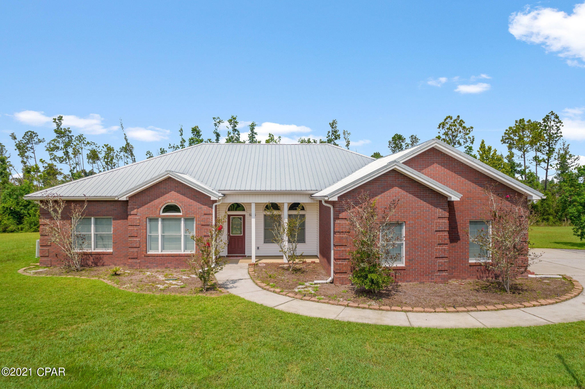 CURRENTLY UNDER CONTRACT, SELLER ACCEPTING BACKUP OFFERS Almost three acres, all-brick home, three bedrooms plus an office AND an in-ground pool  - this home is ready and waiting for you. Conveniently located close to shopping, parks, Tyndall Air Force base and fresh and salt water fun, you have room for family, pets, boats and gardens. As you enter the home, the spacious living room is ahead and the dining room with charming wood floors is to your right. The eat-in kitchen is open to the living room and features granite counters,  all appliances and a pantry. The master bedroom is large and has a door to the pool  and the master bath has double vanities, tub, separate shower and a walk-in closet. The additional two bedrooms are also nice-sized with a jack-and-jill bathroom between. In addition there is an office, a half bath and a laundry room. Outside,  the screened pool area has a covered patio with an attached hot tub and waterfall feature. There is also a pole barn with an enclosed workshop. In addition, there is a large three-car garage with a workbench and additional attic storage. It is hard to find three acres this close to town with a great house and a pool. Call your Realtor for your personal tour today