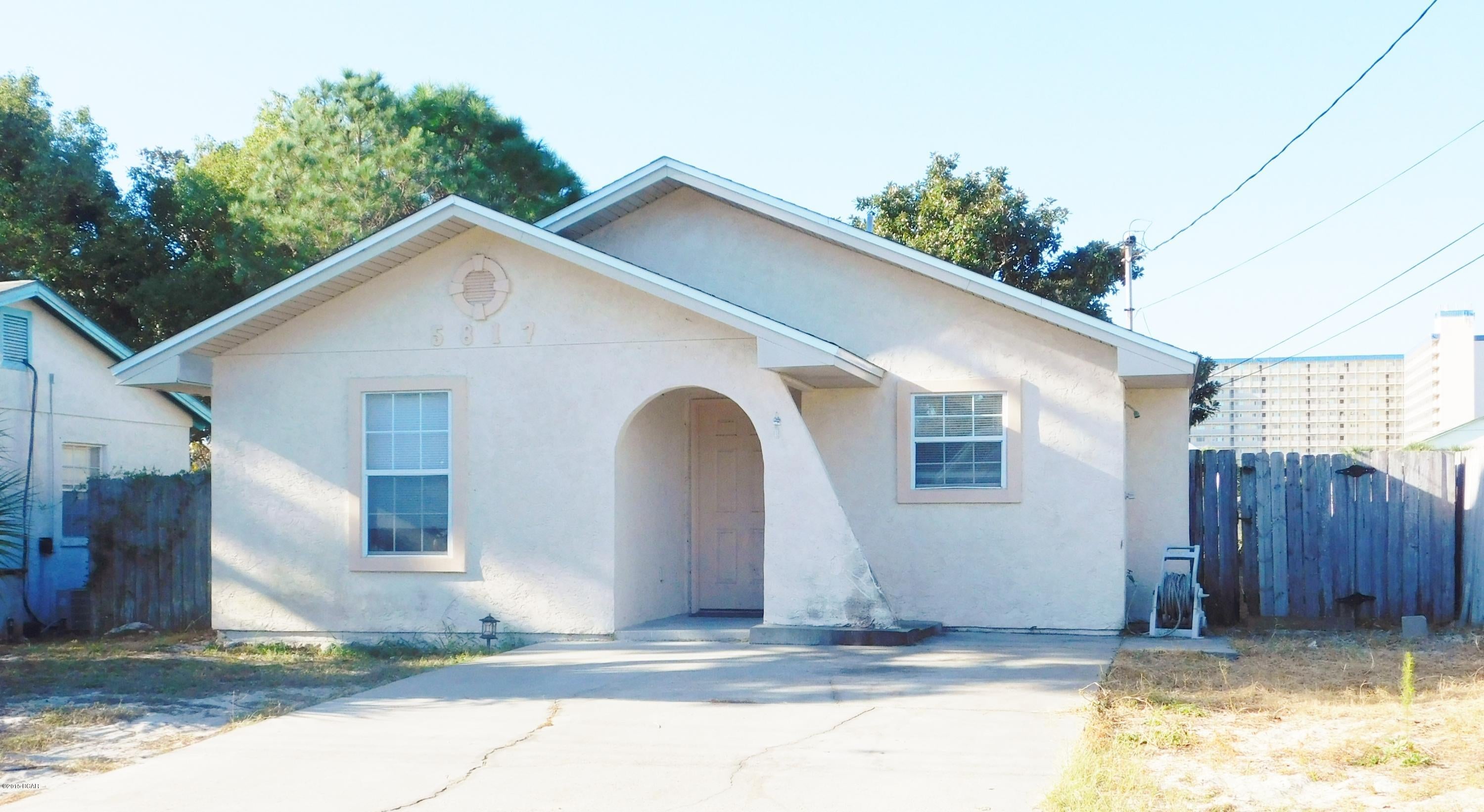 Cute, Cute, Cute! AND Location, Location, Location!  This 2 bedroom bungalow is JUST 2 blocks to Dolphin Street Boat Ramp on Grand Lagoon and across the street from The World's Most Beautiful Beaches and The Gulf Of Mexico!  And it's ''just the ticket'' for a perfect beach hideaway!  Good size great room / dining area with double doors that leads out to fenced back yard and covered patio. Master has walk in closet and also has double doors that lead to patio.  Second bedroom and full bath just off kitchen area which has all appliances and a pantry. AND it's clean as a whistle! Call today for more info!