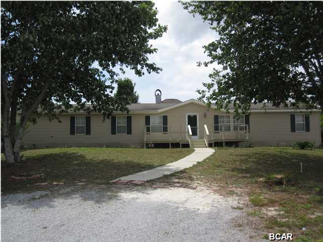 Well maintained home centrally located in a peaceful neighborhood on Panama City Beach. This home has many upgrades including new laminate wood flooring, wood burning fireplace, crown molding, drywall walls, extra insulation and a swimming pool. The open floor plan offers split bedrooms, two living areas, large kitchen with center island and an extra bonus office/nursery off master bedroom. The over sized master bath has garden tub and separate shower. The fenced back yard has huge deck that wraps around the above ground pool and also has a covered area. Click on the photos to see more of what this home has to offer. Call to see before its gone!