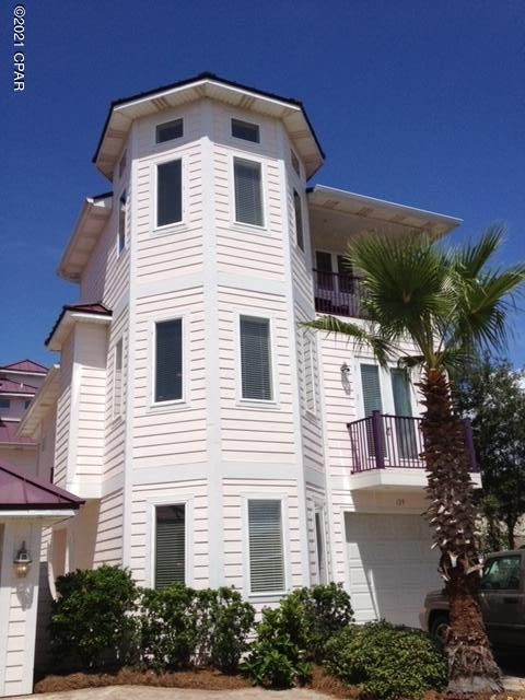 Currently under contract, seller accepting backup offers.  Truly a unique architectural gem, this fabulous 3 story home provides 4 bedrooms, 4 bathrooms, and 4 balconies that easily accommodates 12 or more guests.  The home has a .24 gauge Galvalume standing seam roof, Hardie Board siding, and lush landscaping with a sprinkler system. All bedrooms have newer bamboo flooring; with tile in the kitchen, living, dining, laundry room, and bathrooms.  The entire house is wired for sound and the private elevator provides easy access to the 2nd and 3rd levels of the home.    



The first level of the home provides a second Master Suite, two additional bedrooms, and a shared bathroom.  The garage provides storage for your car or golf cart and your beach supplies. The second level of the home provides an open living area with thick granite countertops, solid wood cabinets, pantry, and newer stainless appliances in the kitchen.  The living and dining area features raised ceilings, multiple windows to allow the light in, and two sets of french doors that lead to balconies; one overlooking a brick-paved gated courtyard and one with a great lake view and partial gulf view.  The living room also has an electric fireplace and a TV niche to accommodate your big screen TV.  A laundry room includes extra cabinets for storage and a laundry sink.  An additional room on the second level can be used as a separate living area, bunk room, or could be easily converted to a 5th bedroom.  
 
The enormous master suite is the entire 3rd level of the home and includes a large walk-in closet and a must-see master bathroom with a whirlpool tub and walk-in shower with two shower heads.  A balcony on the third level provides great lake and gulf views.  An octagonal 14 foot ceiling in the master bedroom shows that this home's unique architectural design continues inside as well as outside.    
129 12th Street is located in Laguna Beach on the desirable west end of Panama City Beach with the beach's white sand and emerald gulf water less than a block away.  This home is ideally located away from the high rise condos and Spring Break crowd; but close to some of Florida's finest restaurants, shopping, and other entertainment options.      

This home has everything you are looking for and is one of very few homes that includes a private elevator.  The home shares an ample brick paved parking area and gated court yard that includes a beautiful fountain with two other identical homes.  A small 3 owner HOA has been established to cover shared energy and water costs; HOA fees are currently $405 per quarter.  So whether you are looking for a great investment rental home, primary residence, or 2nd home, hurry and check this amazing home out before it is gone!