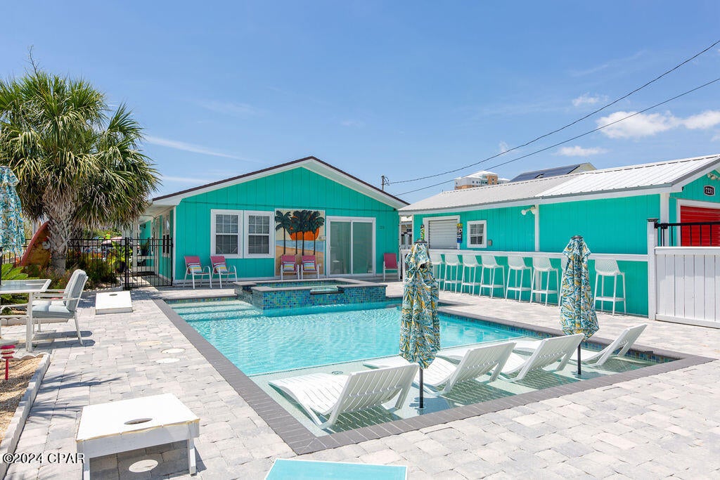 CURRENTLY UNDER CONTRACT, SELLER WILL CONSIDER BACKUP OFFERS Massive rental potential, fantastic location, and outdoor living at its absolute finest... this adorable beach house truly has it all! The outside of this home has been completely upgraded with a paved porch and sitting area, elevated deck with Gulf View, tiki bar, garage parking for a golf cart, boat storage and boat parking alongside the home, plenty of parking, and a beautiful brand new pool area with hot tub! Inside of the home has been well maintained and will be perfect for guests when they are not hanging out in the pool! Prime location just off Thomas Dr., directly behind Finn's Island Style Grub and across the street from Richard Seltzer park... just walk to the beach! The home is also close to Saint Andrews State Park, the many restaurants on Thomas Dr. and very close to local boat ramps as well. The rental potential of this home is off the charts and it will not last long, schedule your showing today!
