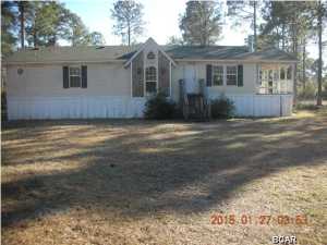 Spacious 3BR/2B mobile home with stone fireplace and vaulted ceiling and located near Wetappo Creek in Gulf County Florida. Being Sold ''AS IS''. Eat in Kitchen with side porch. There is also a dining room. Large carpeted Master Bedroom. Master Bath has Garden Tub and Separate Shower. Two Additional carpeted bedrooms with full bath. Laundry room with door to back yard. This property is on Septic and Well. A Flood zone, per county flood map.