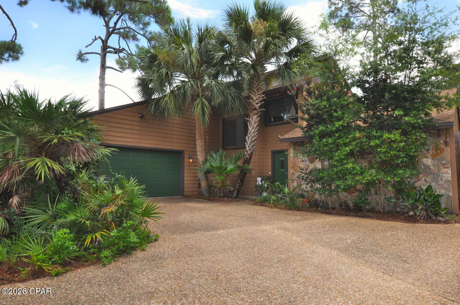 Open and airy home in quiet pocket neighborhood on cul-de-sac overlooking Navy Base wooded area. Vaulted ceiling in sun-filled greatroom with fireplace. Large beautiful wooded yard and less than 2 miles to the Gulf and an award-winning State Park. Fantastic location! Watch wild deer graze along your fence. Constant upgrades over the years. Granite kitchen countertops. Renovated bathrooms with high-end tile and quartzite counters. Cozy loft. Large screened sunroom. Stone patio and fire pit. Luxury vinyl plank flooring throughout. Two outbuildings for storage and/or alternate purposes. Bonus heated and cooled workshop attached to spacious 2-car garage. *** Whole house hurricane shutters installed! Just pull them closed. *** Within past 10 years: new Hardie Board siding, new roof, new HVAC, new hot water heater, new fencing. 5,000 Watt generator with plug for whole-house use. Well on property for irrigation and alternative sourcing. No HOA. Ready to move in!