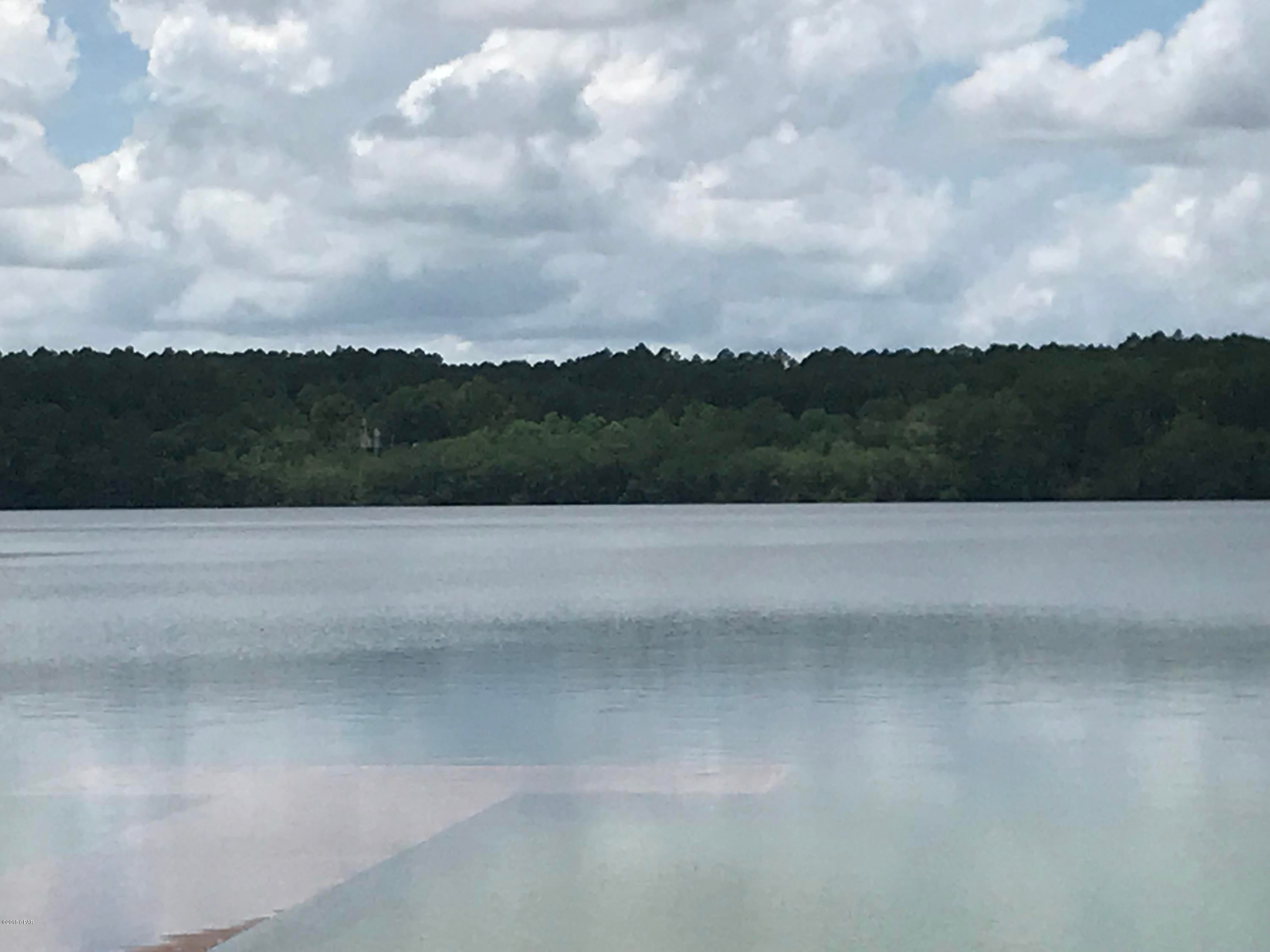 Excellent lot on Lake McCormick.  Approx 297' water frontage this would make a wonderful weekend getaway or possible

home site. This lot is part of Compass Lake in the Hills Subd.  Great amenities come with the property including, pool, lodge with restaurant, horse stalls, picnic area's, cabin rentals and more.  Only about 40 minutes to Panama City Fl and 50 min to the beach.