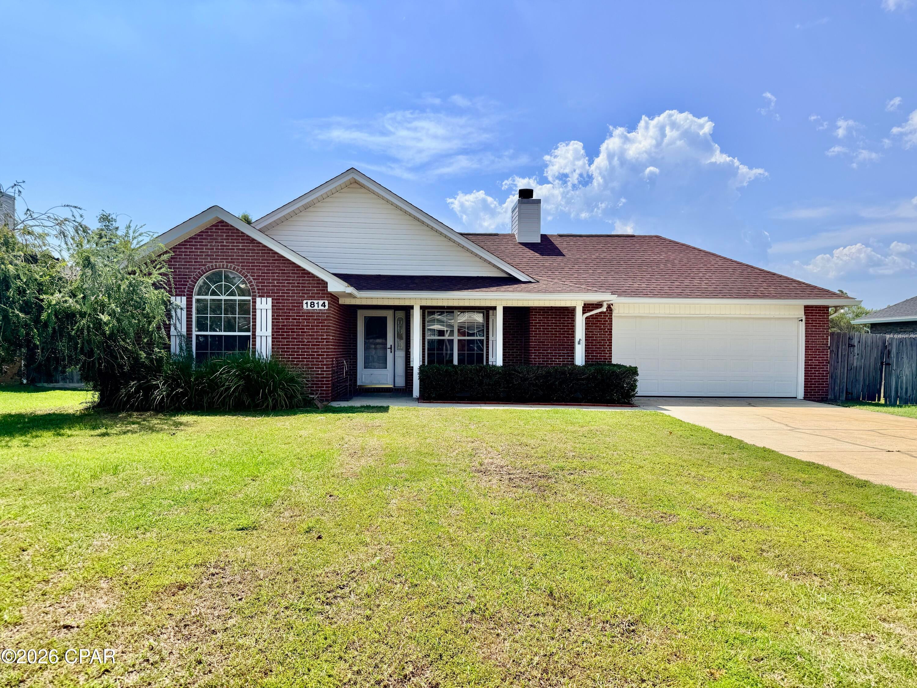 Well-maintained 3BR/2BA brick home in the Magnolia Meadows community of Lynn Haven. This single-story property offers a functional split-bedroom layout with 1,397 sq ft heated, updated vinyl plank and tile flooring, and a comfortable living area featuring a wood-burning fireplace. The home includes a welcoming front porch and a bright kitchen with ample cabinet storage. The primary suite offers a spacious bathroom and walk-in closet. The garage provides dedicated workshop space, ideal for projects or additional storage.  Exterior highlights include a 20x16 storage building, wood privacy fence, sprinkler system, and extended driveway and walkways. Brick construction, newer effective-year components, and a well-kept yard contribute to easy maintenance. Conveniently located close to schools, parks, shopping, and Lynn Haven amenities. Move-in ready and easy to show.