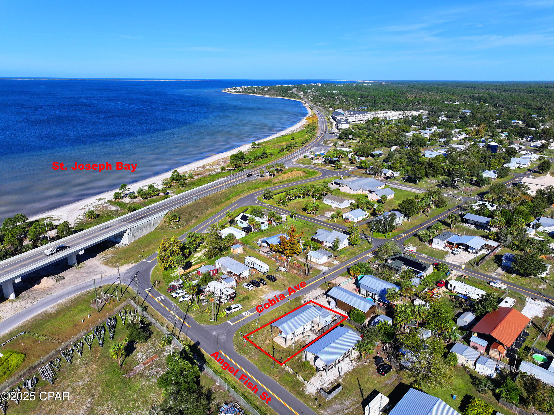 Charming Coastal RV Retreat!!  Discover the perfect blend of comfort and coastal convenience at 215 Angel Fish Street, ideally located just minutes from Downtown Port St. Joe and St. Joe Bay. This 0.11-acre corner lot features a covered pole barn with concrete pad, fully insulated and finished outbuilding with a living area, half bath and a sitting deck. This property is ideal for your RV, boat, or beach toys, and comes equipped with electric, water, and sewer hookups--ready for your next Gulf getaway.  Everything is done for you - RV is included in this wonderful opportunity.  Enjoy peaceful mornings with Bay breezes and easy access to public boat launches, beaches, and the Intracoastal Waterway. The property is fully fenced for privacy, with beautiful tropical landscaping and plenty of room for entertaining or future expansion. Whether you're looking for a vacation retreat, investment rental, or full-time coastal living, this property offers endless potential in a quiet, golf-cart-friendly community.  Located in the Highland View neighborhood--no HOA, close to local seafood markets, marinas, and just a short drive to Cape San Blas and Mexico Beach. Bring your RV or your builder and make this your slice of paradise on the Forgotten Coast!