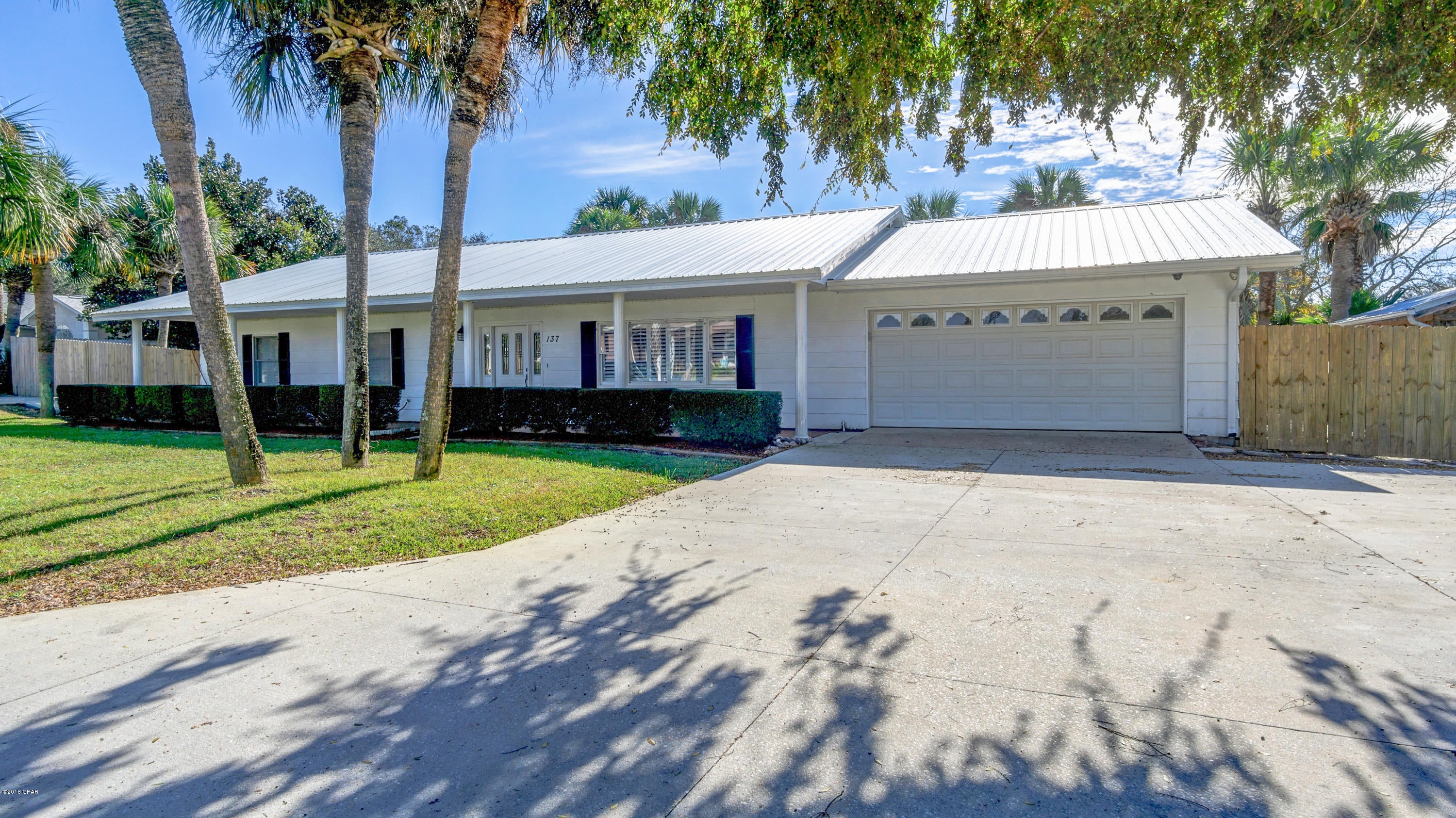 Family Beach Retreat! 1 Block from the Sugar White Sand sits this spacious 4 Bedroom 3 Bath Home with 2 Master Bedrooms. The Large Lot with RV Parking is complimented by Pool and plenty of Parking. The home offers new; roof, gutters, insulation, hot water heater, heating & cooling systems, pool filtration system, septic drain fill, out building, security cameras, tile floors, Plantation Shutters, Lawn Well & Sprinkler System, remodeled bathrooms and landscaping. The large open Kitchen and Dining Room will more than host your next dinner party while gently flowing over into the climate controlled Sn Room and Large Living Room. Located on the West End of Panama City Beach in the Sunnyside Area.