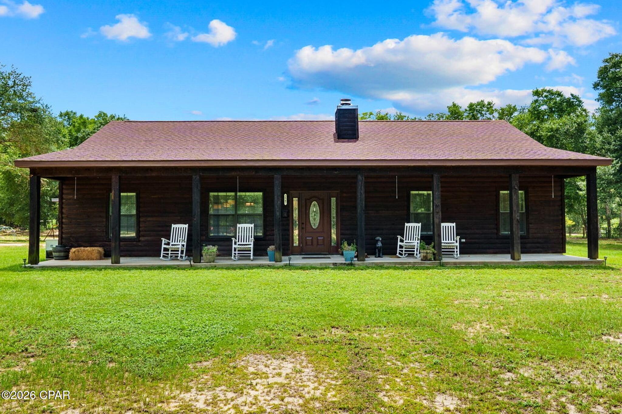 *** OPEN HOUSE August 30th*** Welcome to 2547 Nightfall Place! Step inside this charming rustic cabin-style home with modern finishes situated on 4.52 acres of unrestricted land. 

Offering 4 bedrooms, 3 full bathrooms with a split bedroom floorplan nestled in a quiet country setting providing a perfect opportunity for avid homesteaders looking for a private retreat! 

Entering you will be greeted with a open-concept living area with soaring vaulted ceiling featuring beautiful knotty pine accent walls, and a floor-to-ceiling stone wood burning fireplace.

Wood-look tile flooring flows throughout the main living areas, while all bedrooms feature carpeting. Built with durable log cabin siding, the home also offers energy-efficient open-cell spray foam insulation in both the walls and attic, along with 9-foot ceilings throughout, except for the living room.

Beyond the living room, is the warm an inviting kitchen complete with quartz countertops, all-wood cabinetry, stainless steel appliances, pantry and the center piece- butcher block island.

The private primary suite offers a relaxing retreat with walk-in closet, and spa-inspired bathroom complete with a soaking tub, separate shower, double vanity, and tile flooring. Adjacent to the primary suite is a versatile bonus room, ideal for a coffee bar, home office, or additional pantry and storage space.  Down the hall is a bedroom currently being utilized as a craft room. Further down, is a full bath and generously sized laundry room adds even more convenience. Tucked away on the opposite side of the home are two additional bedrooms and a full bathroom, offering privacy and comfort for family or guests.

Just off the kitchen, French doors open to a newly constructed 18' x 32' screened porch, creating the perfect outdoor living space to relax, entertain guests, or enjoy peaceful country views year-round. The home also includes a newly added attached single-vehicle carport. 

Outside, you'll find exceptional amenities designed for both work and recreation. A 24' x 36' wired outbuilding that was partially designed as a workshop/bunkhouse. Complete with a full bathroom featuring a shower, window A/C unit, and washer/dryer hookups, this versatile space could easily be converted into a guest house, home business, hobby space, or recreational retreat.

At the rear of the property, a newly constructed 30' x 48' pole barn with four spacious bays provides abundant covered storage for farm equipment, recreational vehicles, boats, trailers, or machinery. The property also features a large garden area with water access and plenty of room to expand, along with a custom-built chicken coop ready for your flock. 

The property is equipped with two 200-amp electrical services, two separate septic systems, and an RV hookup, offering outstanding flexibility for future expansion or multi-use living. 

Fully fenced with an electronic entrance gate, the property is shaded by beautiful mature oak trees and surrounded by abundant wildlife and natural beauty, creating a peaceful setting where you can embrace country living while remaining just a short drive from shopping, dining, and everyday conveniences.

With its unique blend of rustic charm, modern amenities, versatile outbuildings, and unrestricted acreage, 2547 Nightfall Place offers endless possibilities. If  you're dreaming of a family retreat, with room to grow and enjoy the outdoors, this exceptional property is ready to welcome you home.