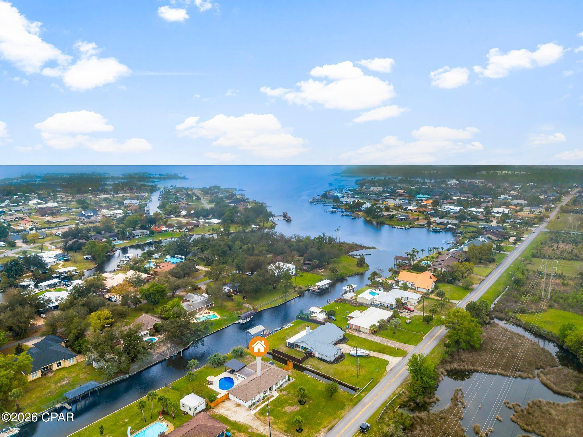 Welcome to waterfront living in the heart of Lynn Haven. Ideally situated on North Shore Road, this beautifully updated canal-front home features 3 bedrooms, 2 bathrooms, and 2,120 square feet, along with 125 feet of waterfront, a private pool, and direct water access. Offering the perfect blend of comfort, style, and coastal lifestyle.

From the moment you enter, you're greeted by a grand foyer that sets the tone for the home. Just off the entry are two spacious and versatile rooms, ideal for a formal dining room and a refined sitting area or home office, perfect for both everyday living and entertaining.

The kitchen is thoughtfully designed for a true home chef, featuring ample workspace, abundant cabinetry, and all new appliances (2024). The layout flows seamlessly into the main living areas, creating an inviting space to gather. Just beyond, the oversized utility room offers exceptional storage and functionality, an incredibly rare and practical feature.

The primary suite offers a beautifully updated bathroom with modern finishes, featuring a step-in shower with floor-to-ceiling tile for a clean, elevated look. The guest bathroom is equally well-appointed with a tub/shower combo and striking mosaic tile carried floor to ceiling.

Step outside to your private backyard retreat where a sparkling pool is complemented by lush, mature landscaping and a modern pergola designed to accommodate both an outdoor living area and dining space. With 125 feet of canal frontage, this property offers direct water access, making it ideal for boating, kayaking, or simply enjoying the coastal lifestyle.

Major system updates provide peace of mind, including a new HVAC system and ductwork (2025), new pool pump, sand filter, and liner (2025), water softener (2023), roof (2019), and seawall (2013).

Located in the highly desirable Lynn Haven area, this home offers convenient access to top-rated schools, parks, shopping, and dining, while remaining just a short drive to Panama City, St. Andrews, and the white sandy beaches of Panama City Beach.