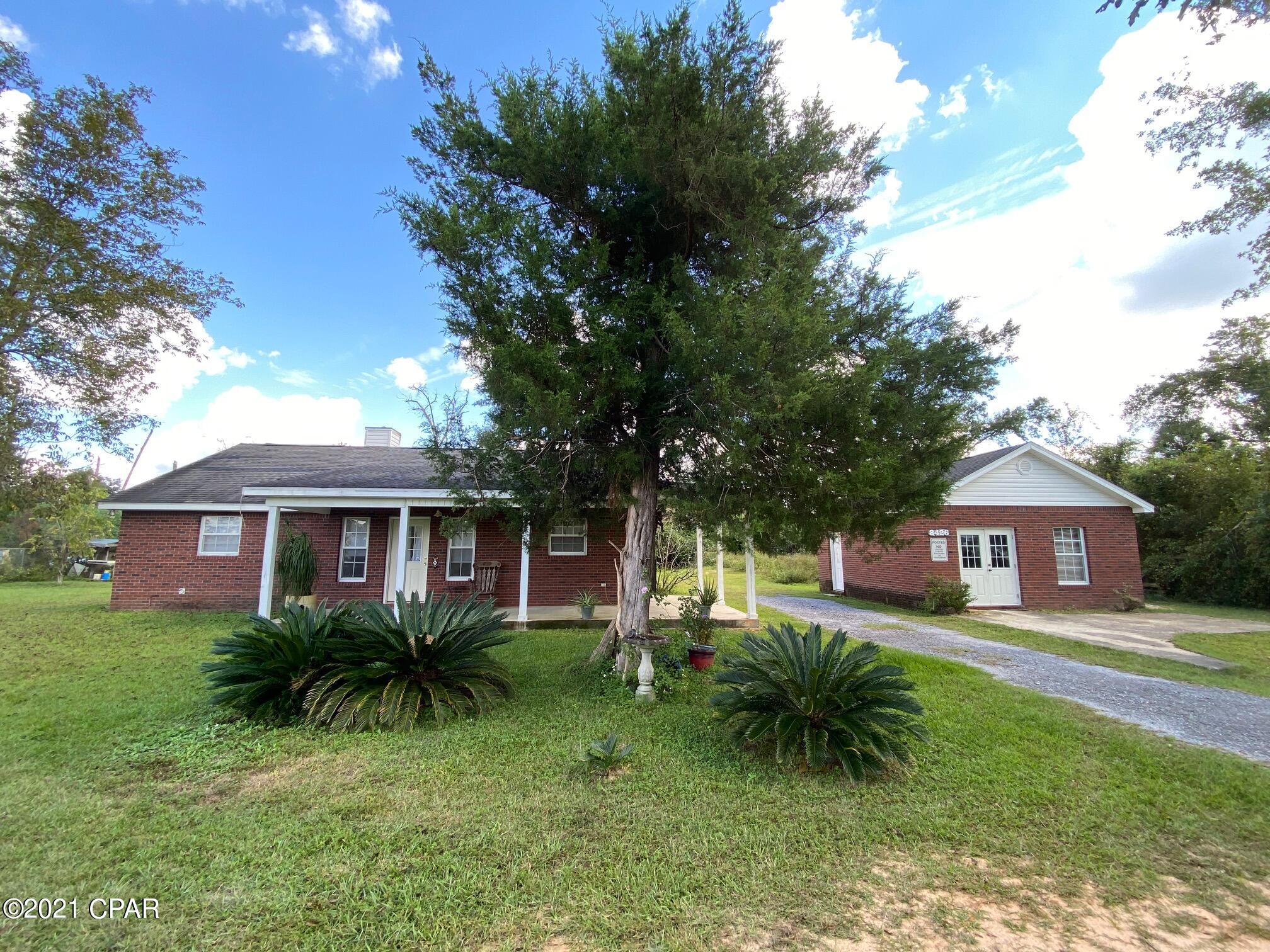 Check out this cute 2 bedroom, 2 bath home just north of Panama City that sits on almost 1 acre of land!  The square footage is used well in this home.  The eat-in kitchen has ample counter/cabinet space.  The living room has a wood burning fireplace that is double sided with the master bedroom.  The master bedroom has a walk-in closet plus an additional closet.  The master bath has a step in shower and a tub.   Split bedroom floor plan.  Nice back patio for cook-outs!  The front porch is perfect for your rocking chairs.  There's a 20 x 20 brick outbuilding that was going to be a guest house.  It has water and electric lines run to it.  There's another 10 x 18 storage building with electricity.  This is the perfect starter or retirement home!  Call today to schedule your private tour.