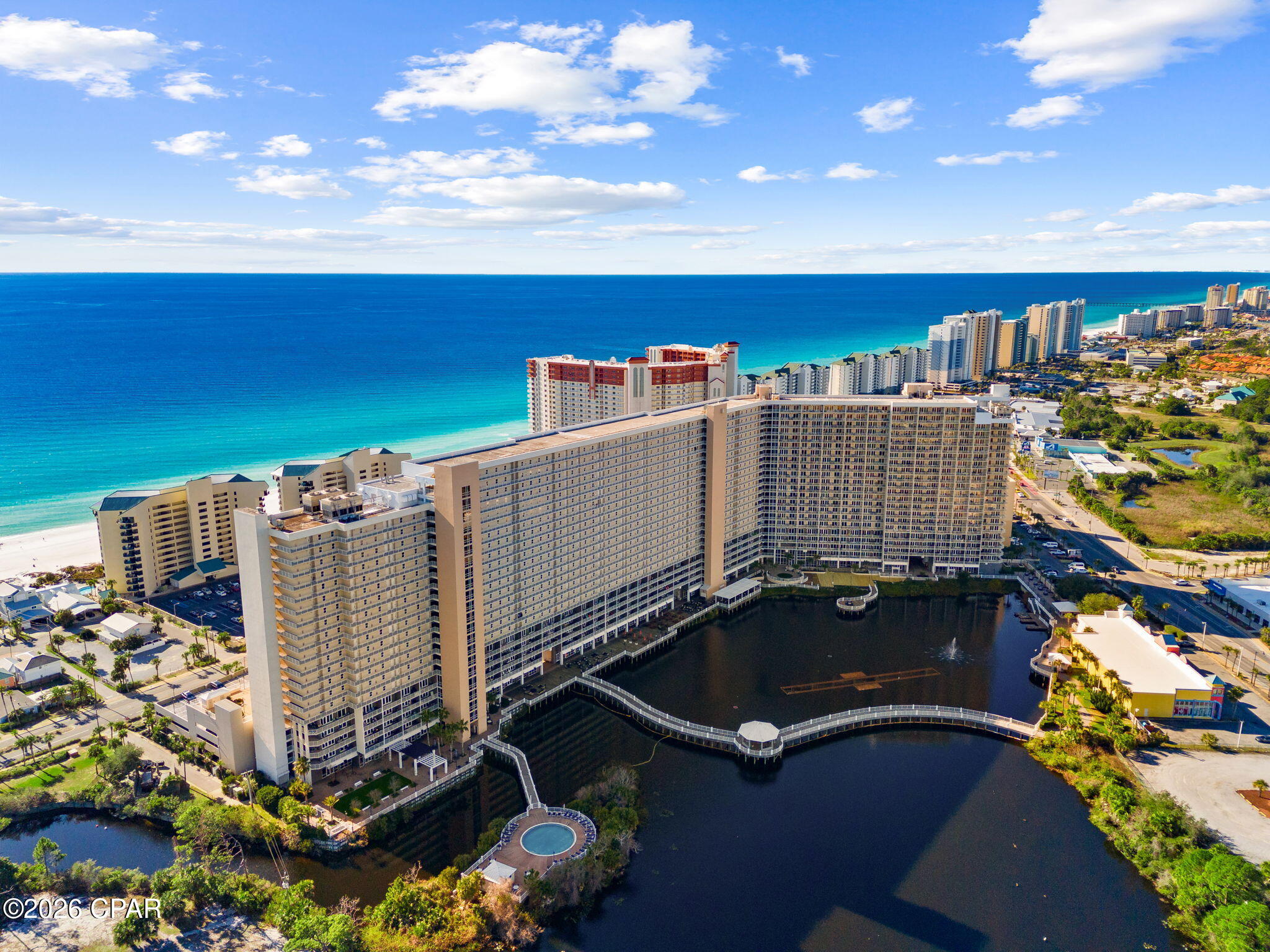 Absolutely stunning Penthouse Condo offering sweeping views of the emerald waters and sugar-white sands of Panama City Beach! This beautifully updated unit features 12-foot ceilings and vestibule windows that fill the space with natural light and breathtaking Gulf views. Recent updates include new flooring, stylish light fixtures, a tiled kitchen backsplash, and a beautifully tiled master shower. 

Floor-to-ceiling glass doors lead to a private balcony where mornings begin with the sound of the waves and evenings end with unforgettable sunsets over the Gulf.

Inside, the open living and dining space is designed to make the most of the view, creating a relaxed coastal atmosphere ideal for unwinding after a day on the beach. The kitchen provides plenty of cabinet space and a functional layout for preparing meals before heading out to explore the area's restaurants, attractions, and entertainment.

The primary suite offers a peaceful retreat with direct Gulf views and private balcony access, allowing you to wake up to the sound of the surf. Additional sleeping space makes this property ideal for hosting guests or maximizing rental potential.

Located within Laketown Wharf, residents and guests enjoy resort-style amenities including multiple pools, lakefront boardwalk, fitness center, and easy beach access just across the street. With dining, shopping, and entertainment within walking distance, this property places you in the center of everything Panama City Beach has to offer.

Whether used as a vacation escape, income-producing rental, or personal beach retreat, this condo offers the chance to enjoy the coastal lifestyle from one of the most sought-after vantage points on the Gulf.
